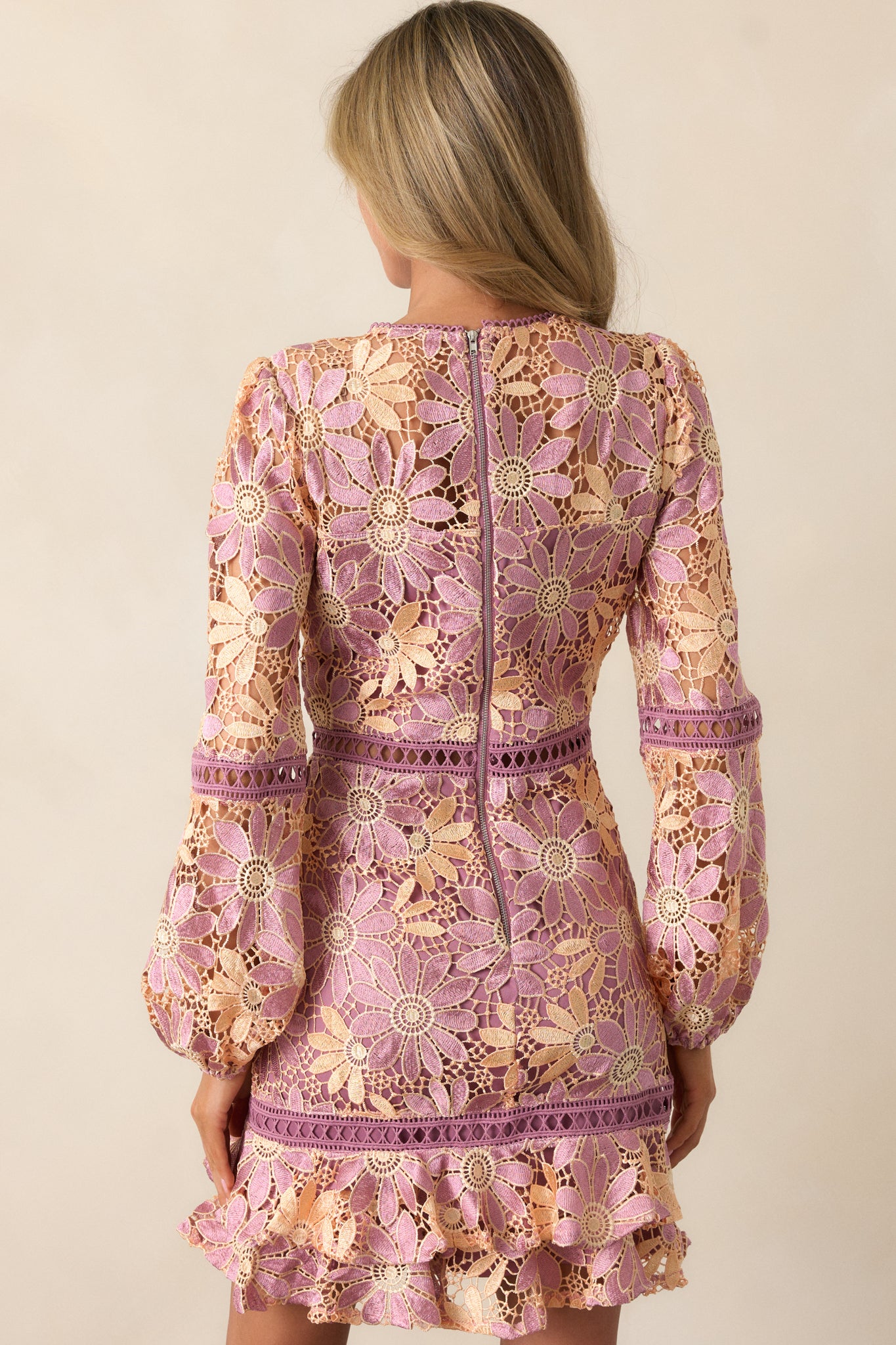 The back of the camel mini dress, displaying the babydoll silhouette and the gentle flow of the ruffle detail.