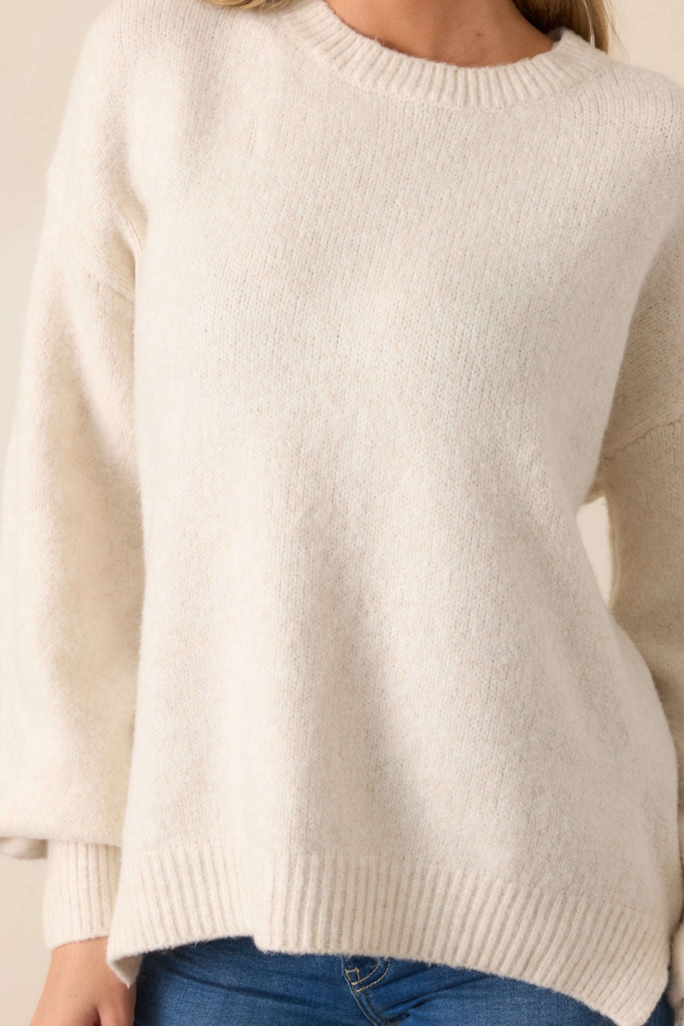 A detailed close-up of the sweater’s fabric, highlighting the texture and quality of the high-quality material used.