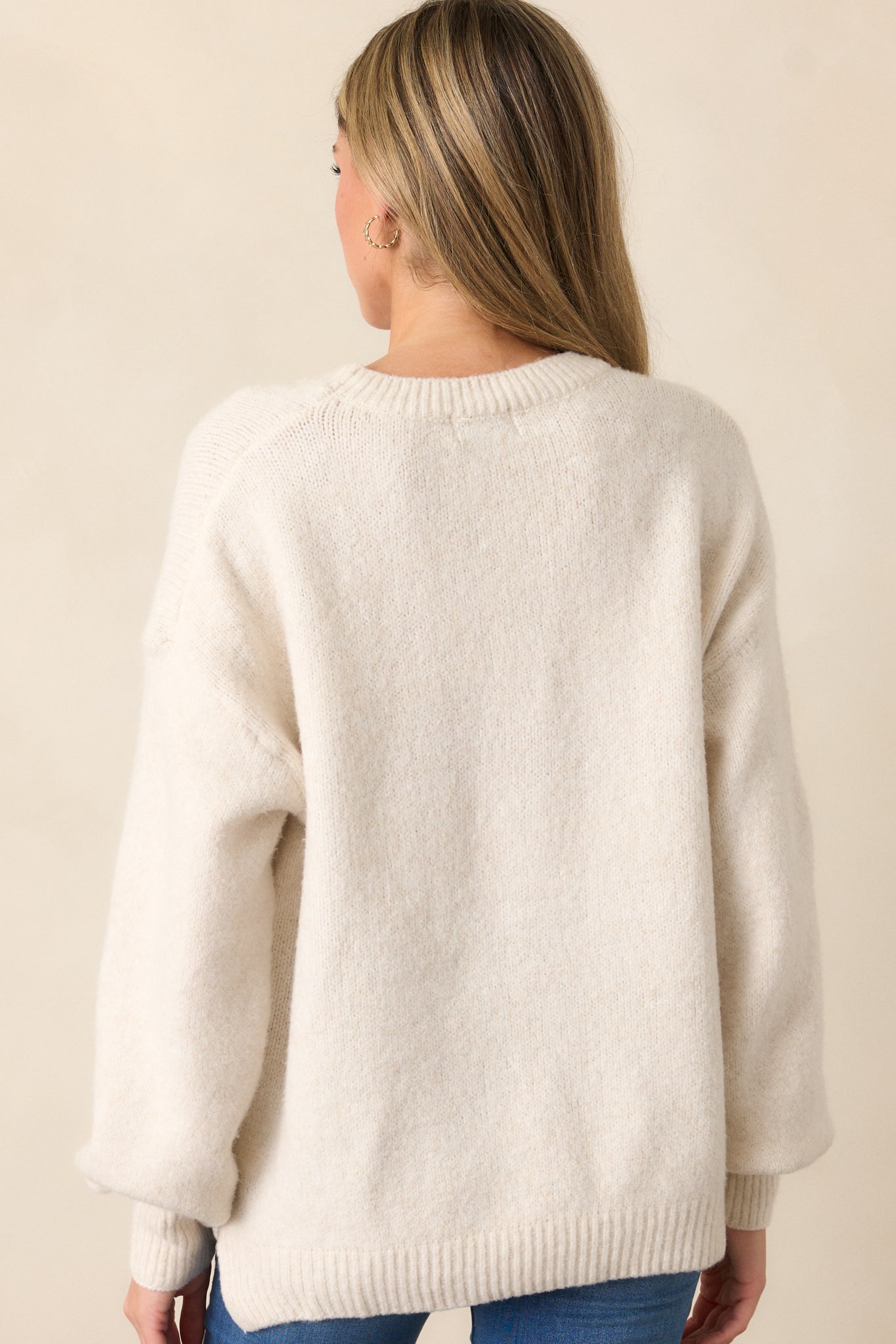 A back view of the sweater, showing its simple yet stylish back design, with a clear view of the unique cut and fit.