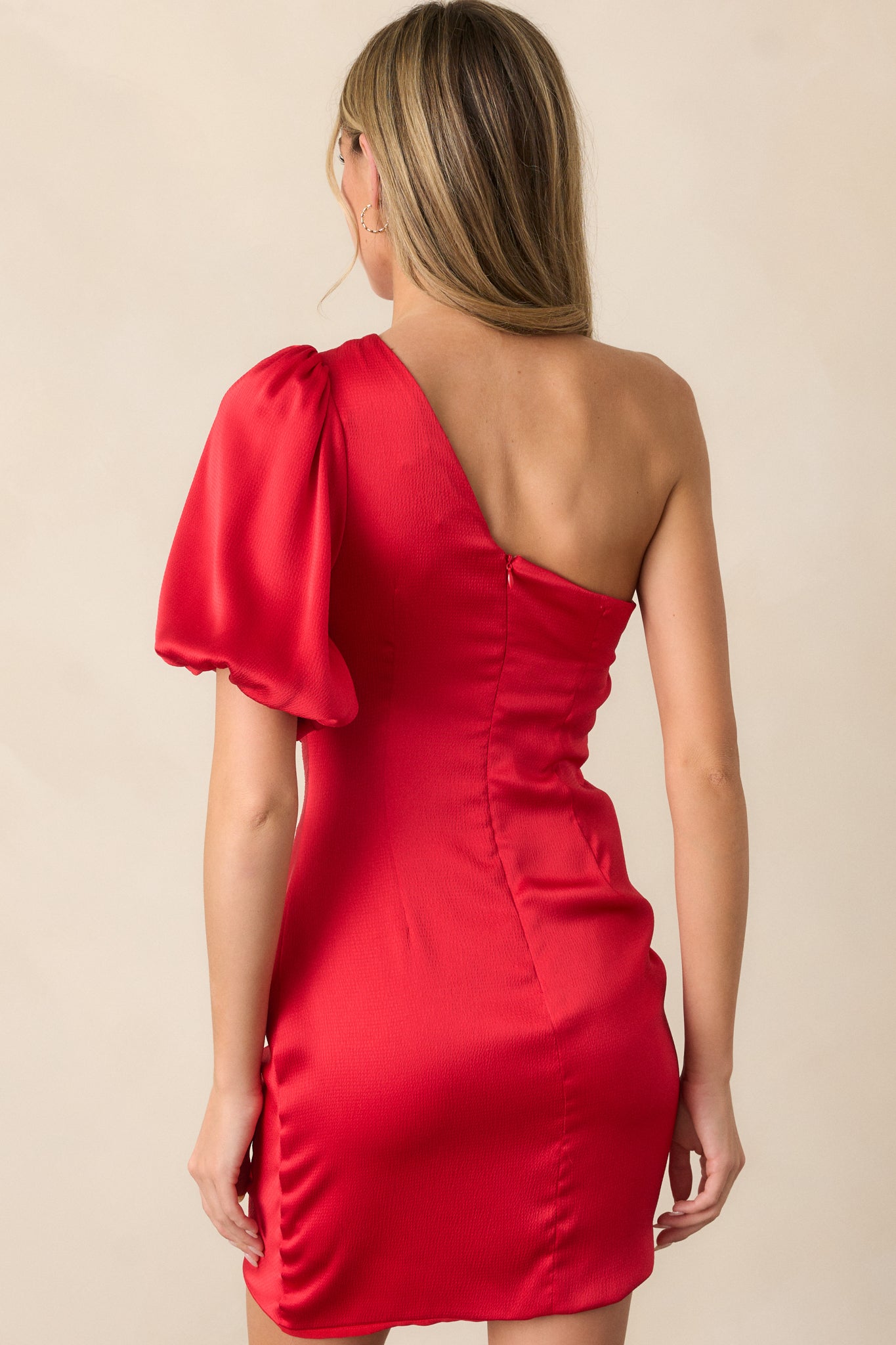 A close-up of the back of the mini dress, showing the hidden zipper closure and the overall clean and smooth back design.