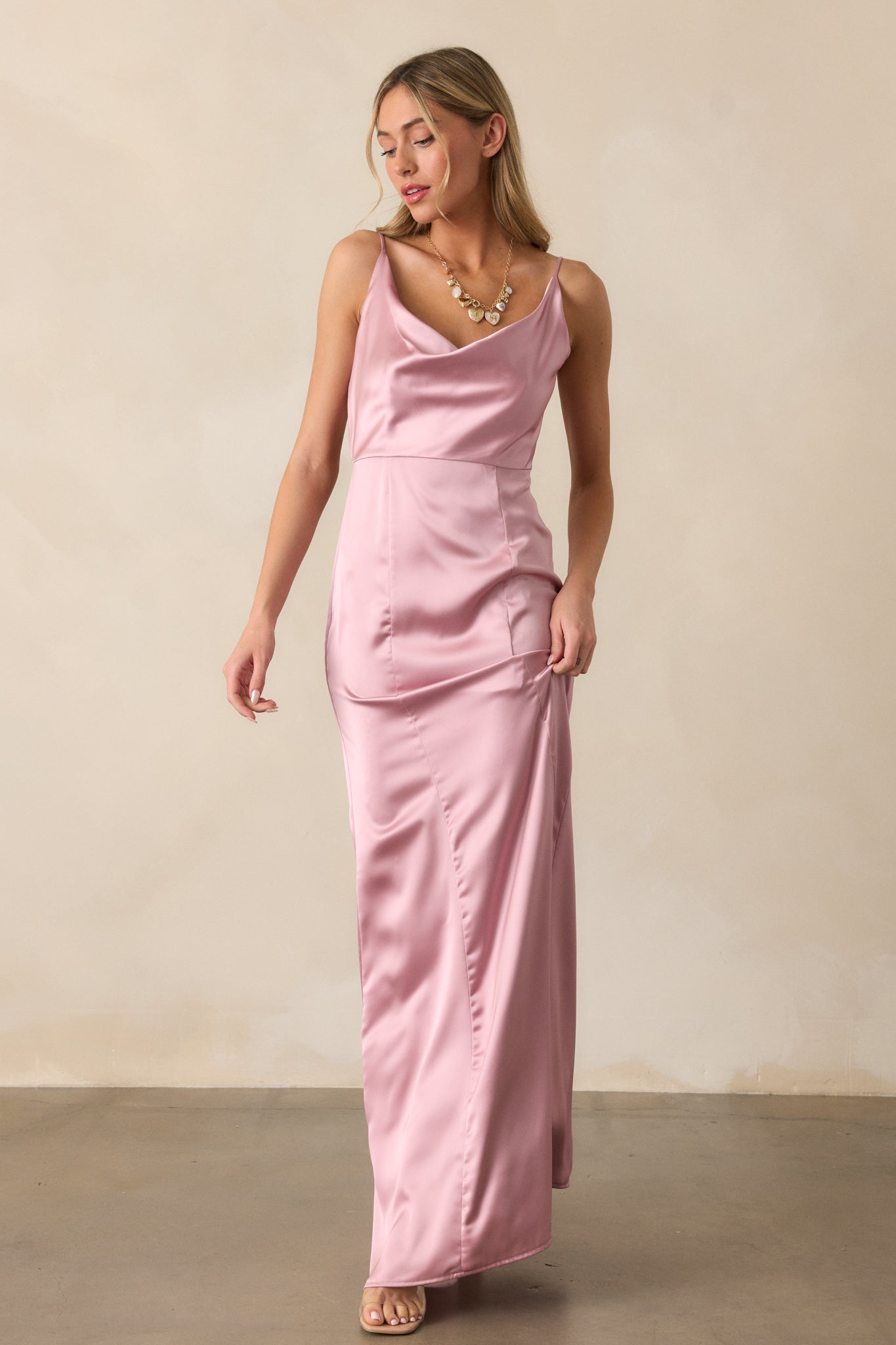 The blush maxi dress styled to highlight its flattering draped neckline and the smooth, seamless fabric of the bodice.