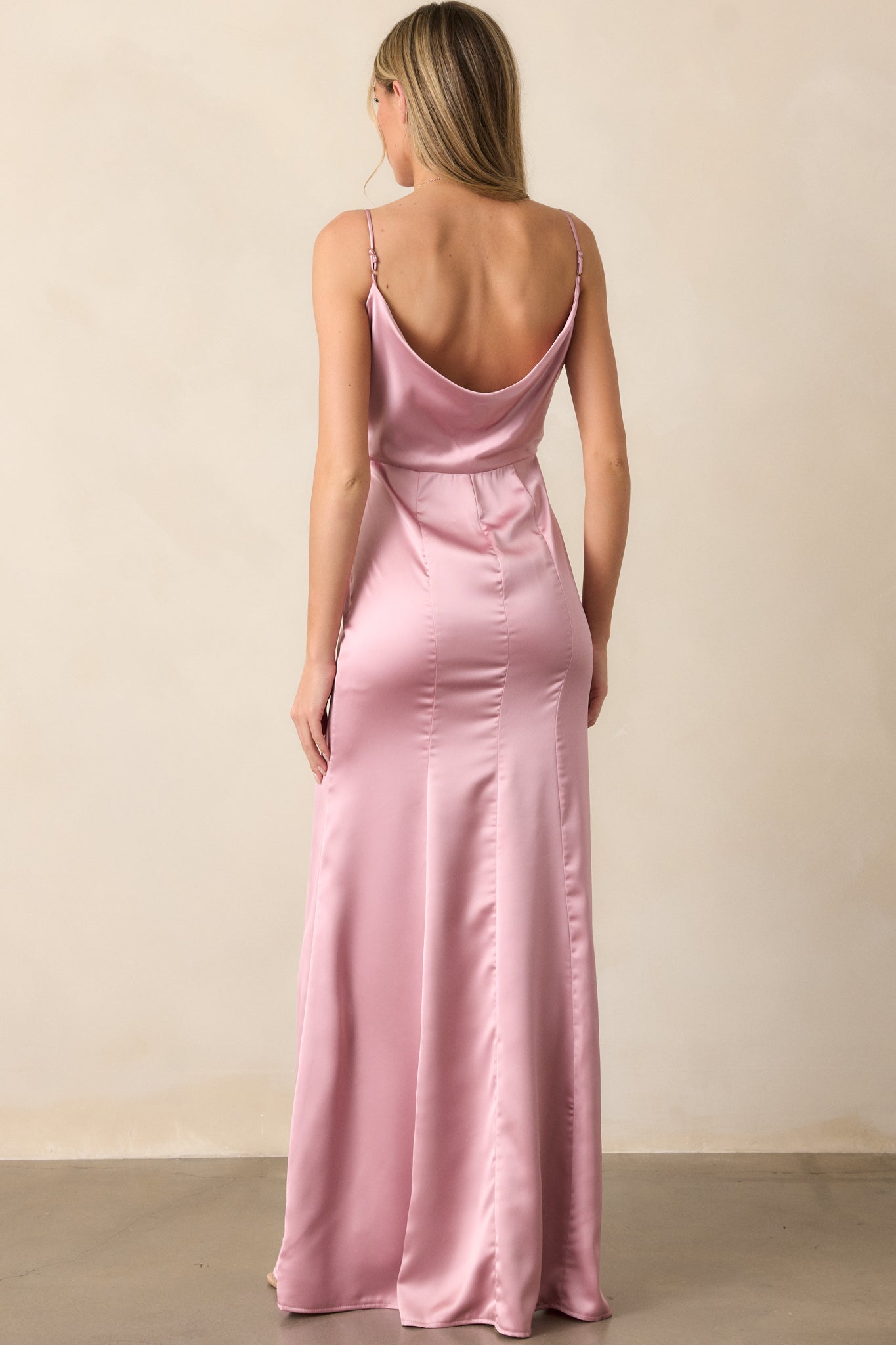 The back of the blush maxi dress, revealing the adjustable straps and the clean, flowing design that extends to the hem.