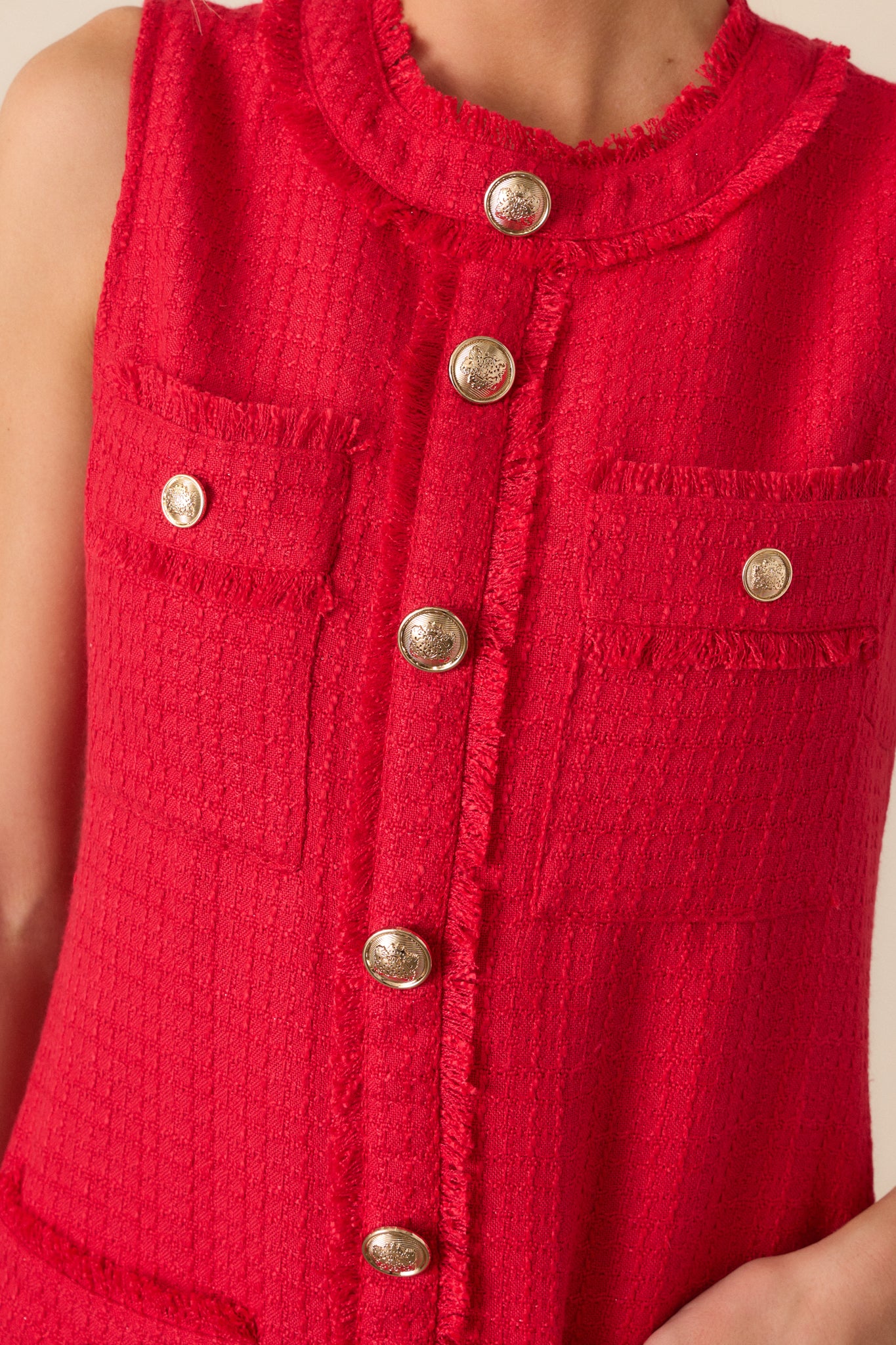 A close-up of the dress’s gold embellished faux buttons, capturing the intricate detailing and craftsmanship.