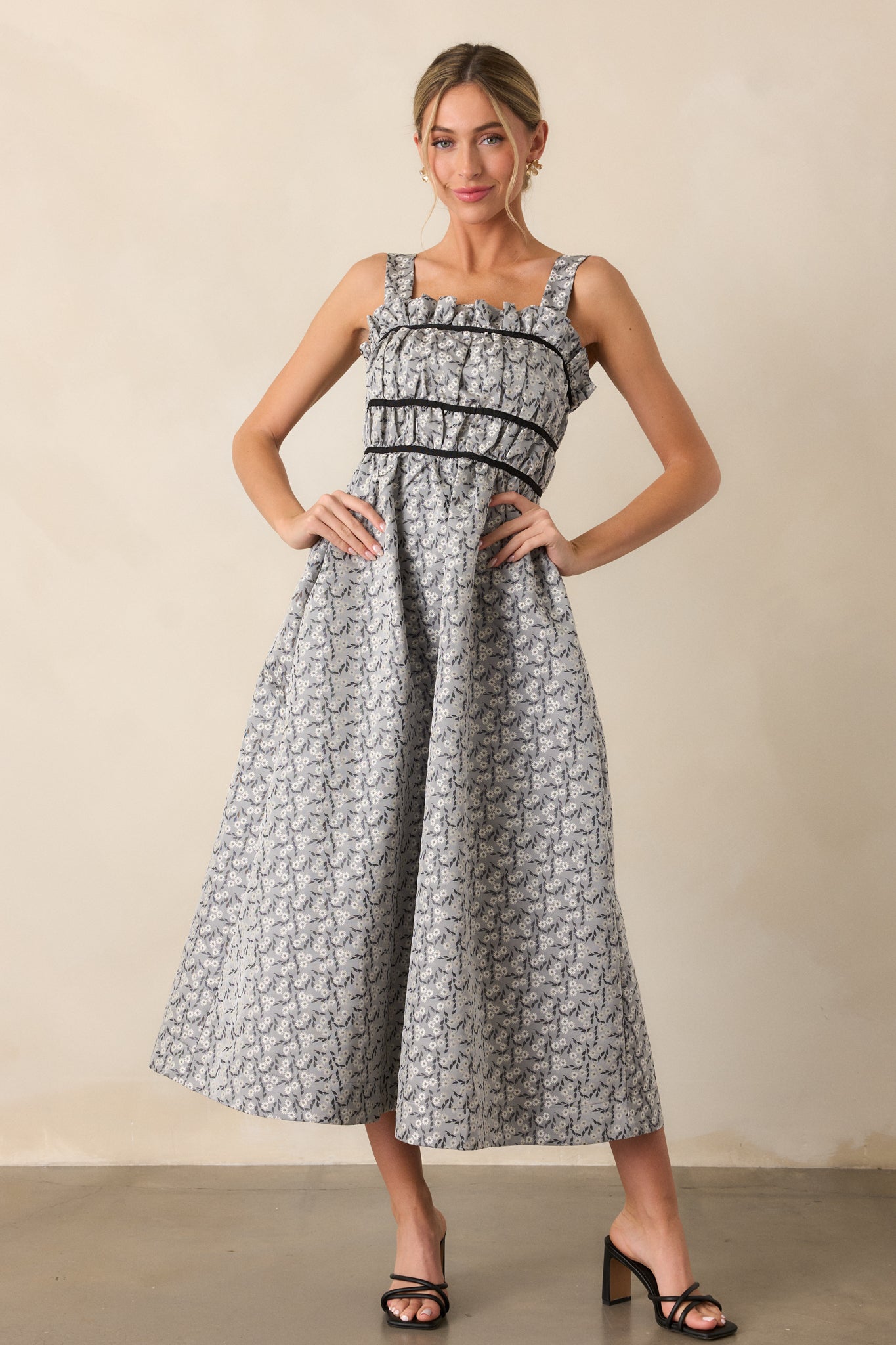 The grey dress displayed in full view, highlighting the mini-length liner and the stylish design details, including the back self-tie bows.