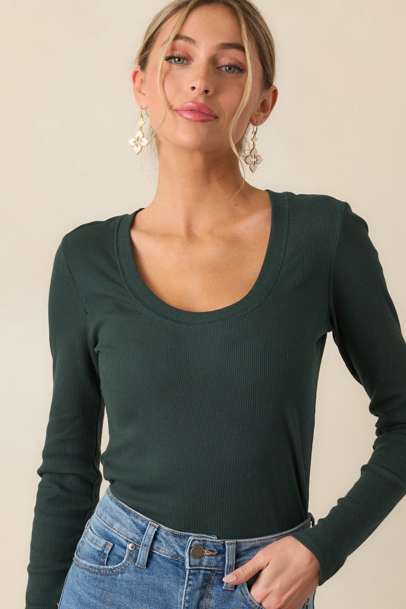 This green top features a scoop neckline, ribbed detailing, and long sleeves.