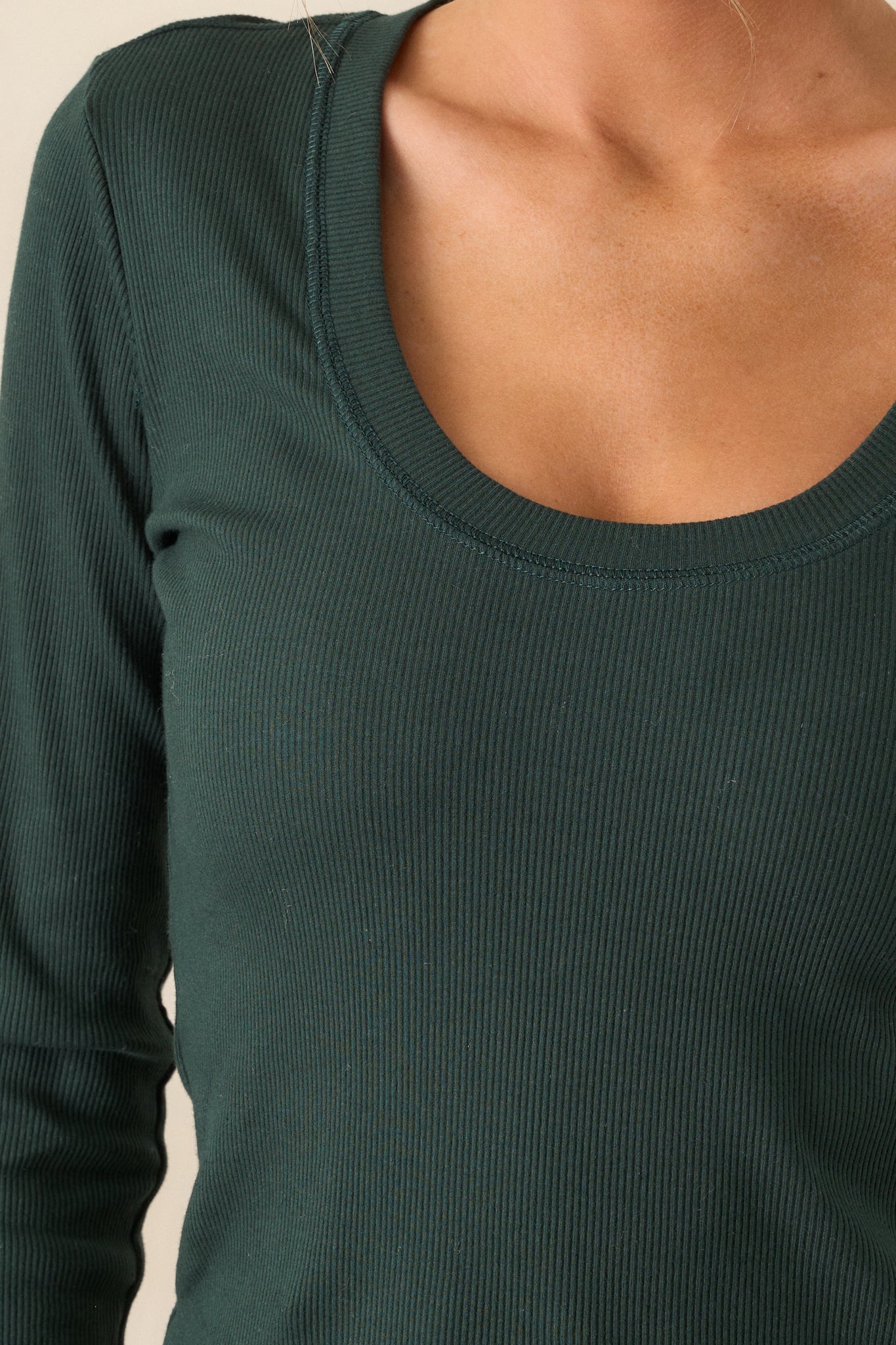 Close-up of the green top showing the scoop neckline and ribbed detailing.