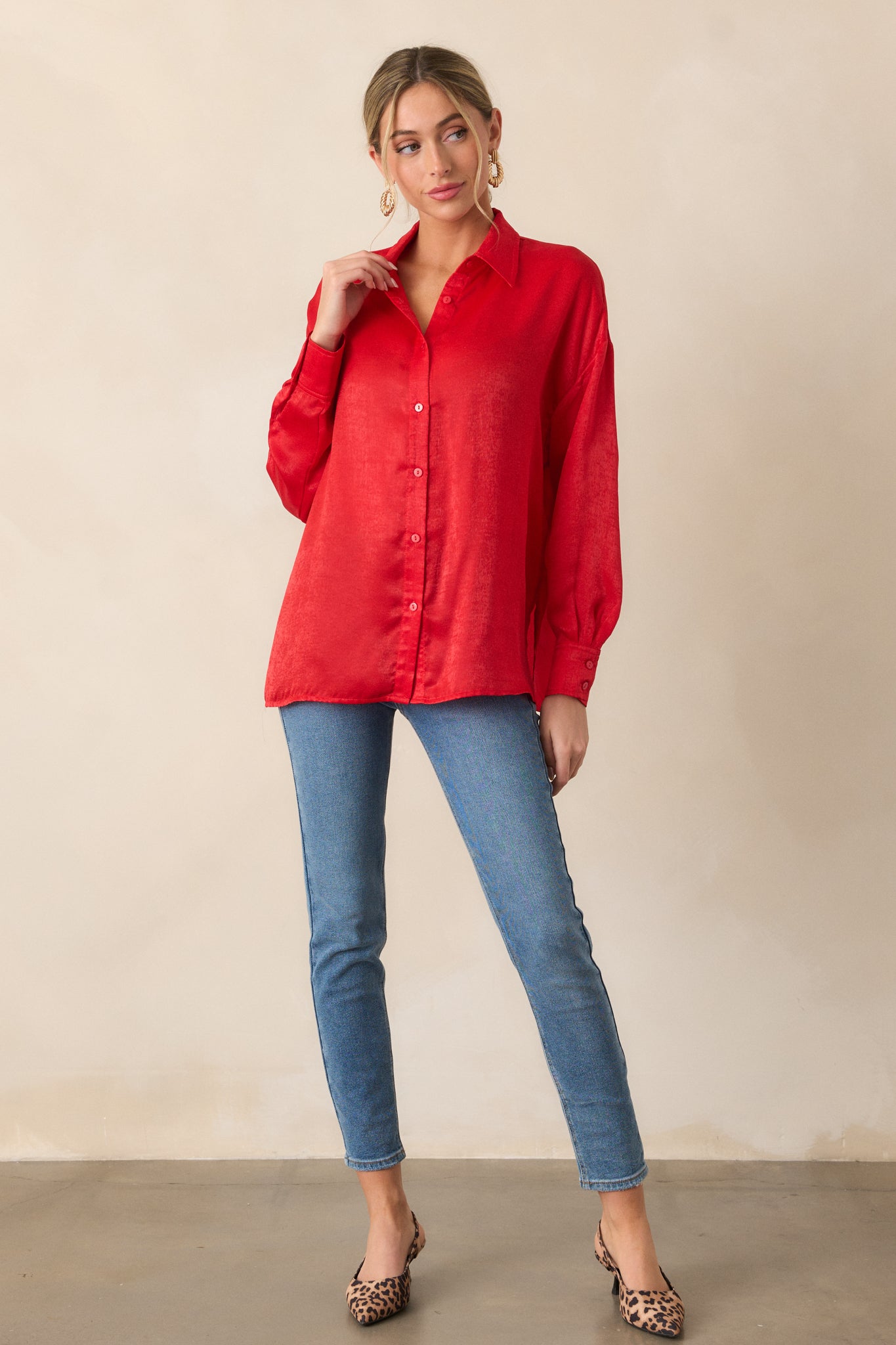 Another full-body shot of the red top with its classic relaxed fit, collared neckline, and button details at the front and cuffs. The top flows comfortably over the body.