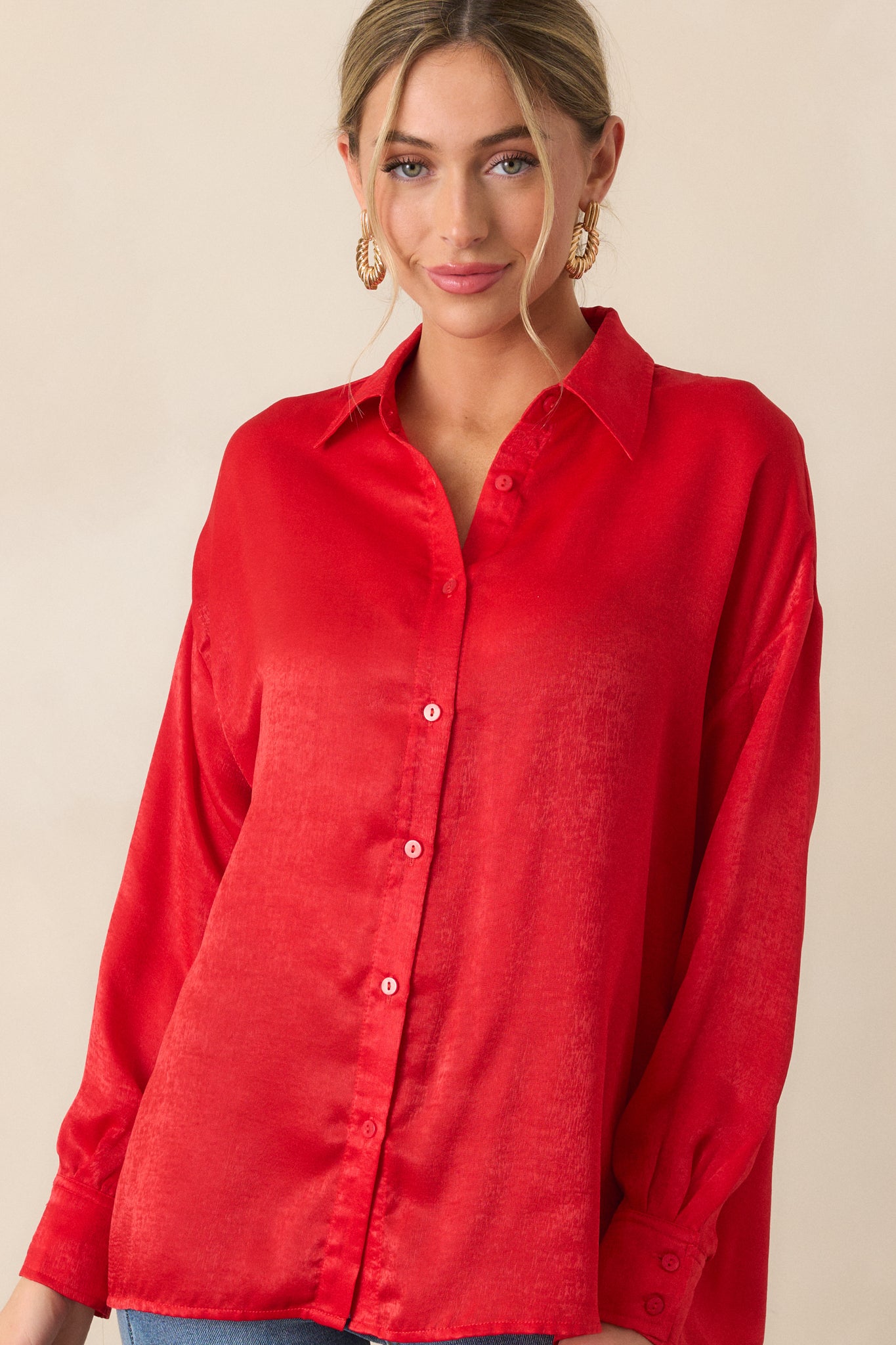 Another front shot of the red top with its classic relaxed fit, collared neckline, and button details at the front and cuffs. The top flows comfortably over the body.