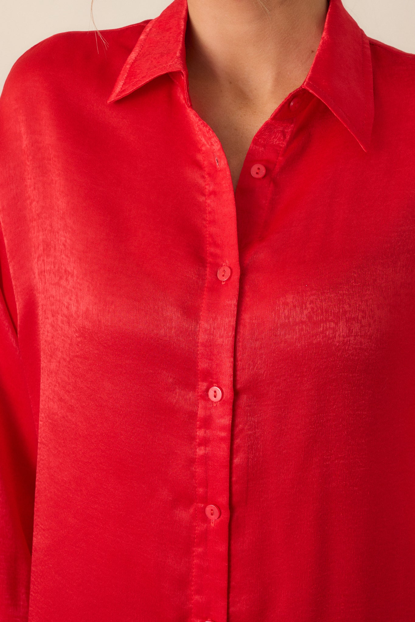 Close-up of the top’s collar and button details, focusing on the buttons down the front and the smooth fabric that gives the top its relaxed fit.