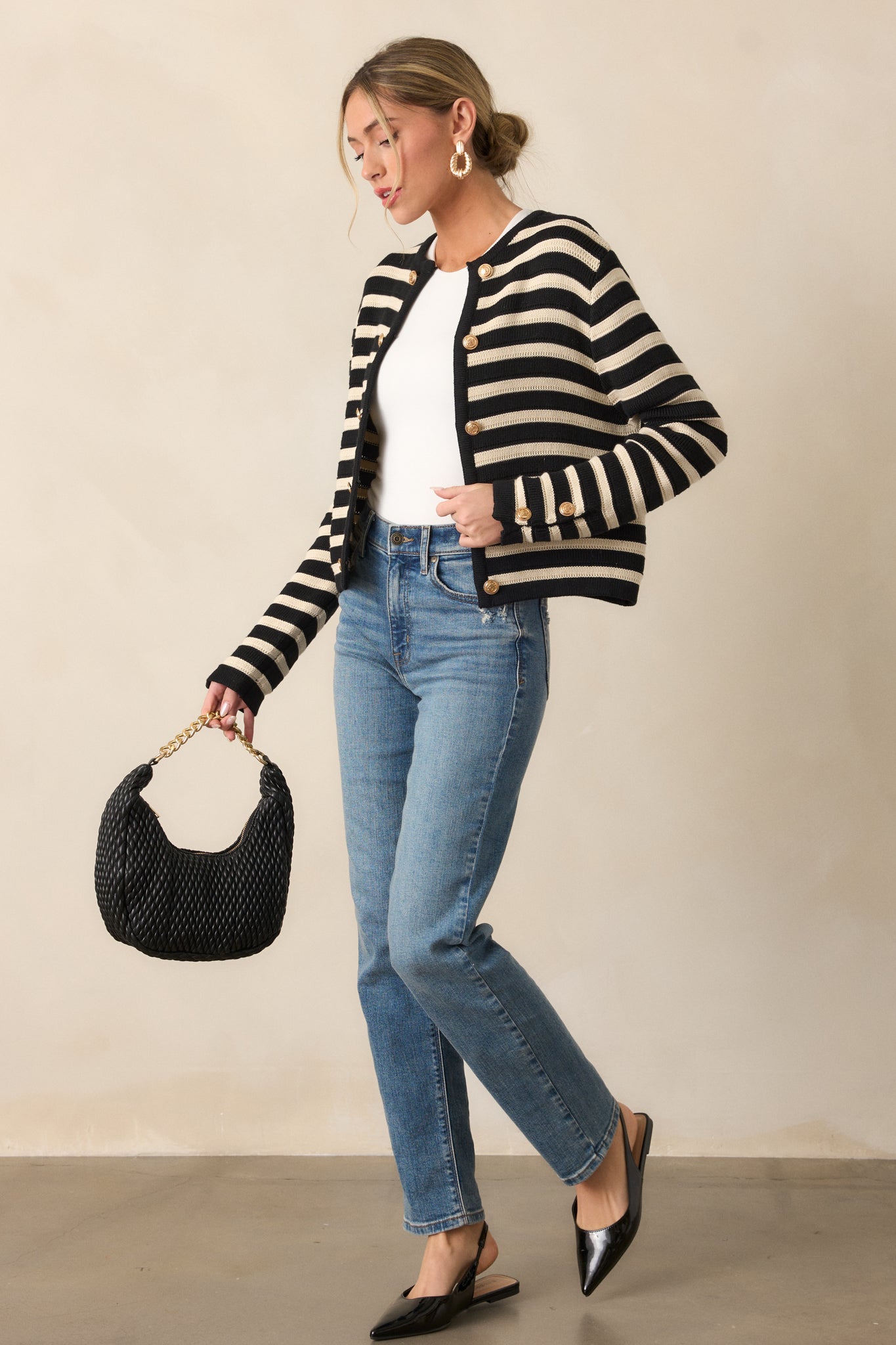 Side view of the cardigan, highlighting the long sleeves with button detailing and the placement of the stripes along the body and sleeves.