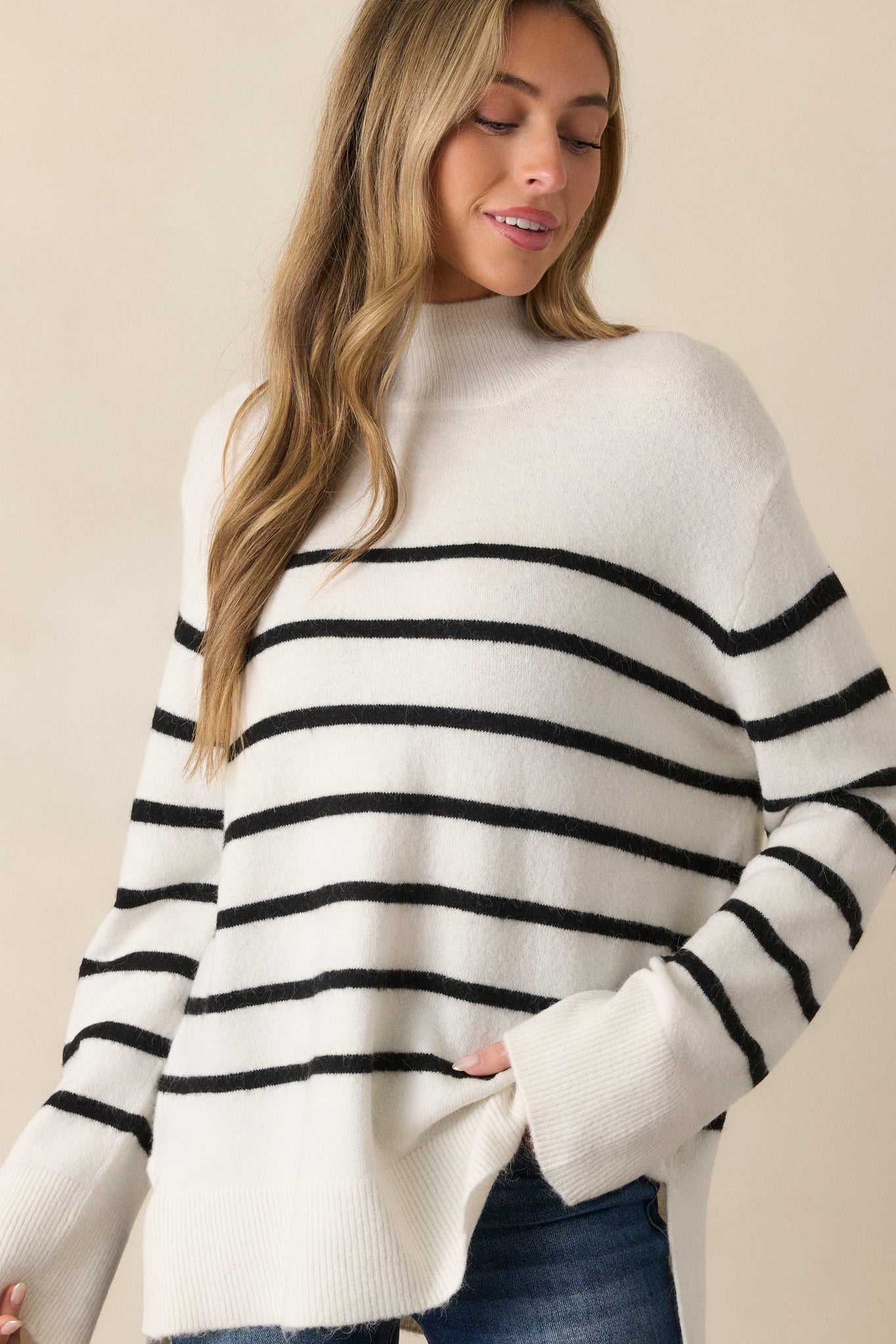 Cropped view of the sweater's neckline, emphasizing the high mock turtle collar and fine rib knit texture.