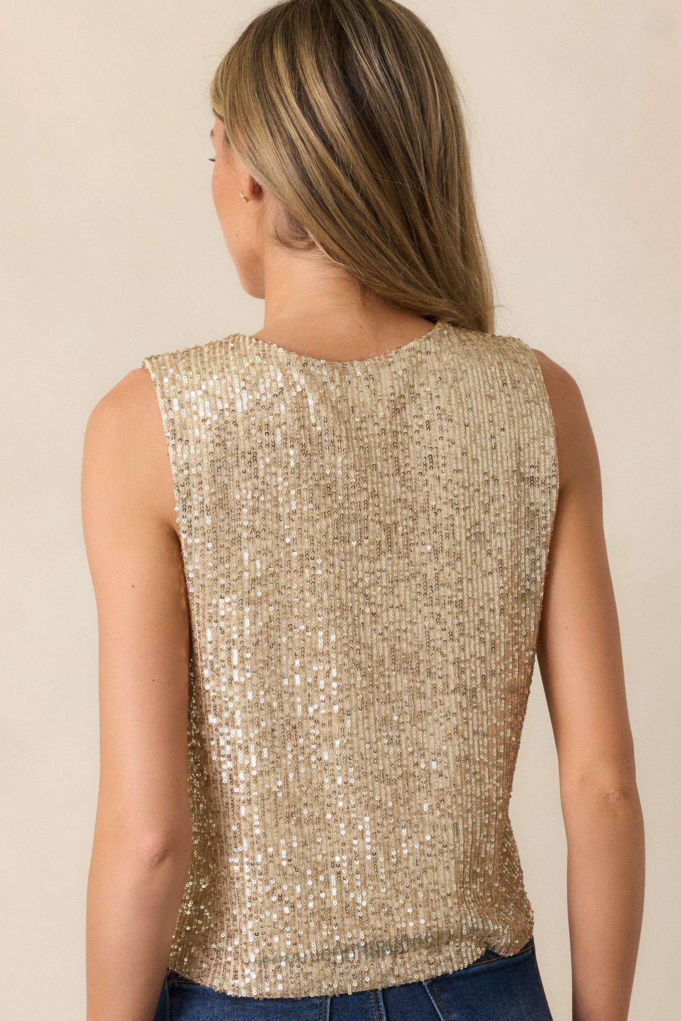 A back view of the champagne tank top, displaying the sleeveless design and the sequin fabric continuing around to the back for a consistent shiny look.