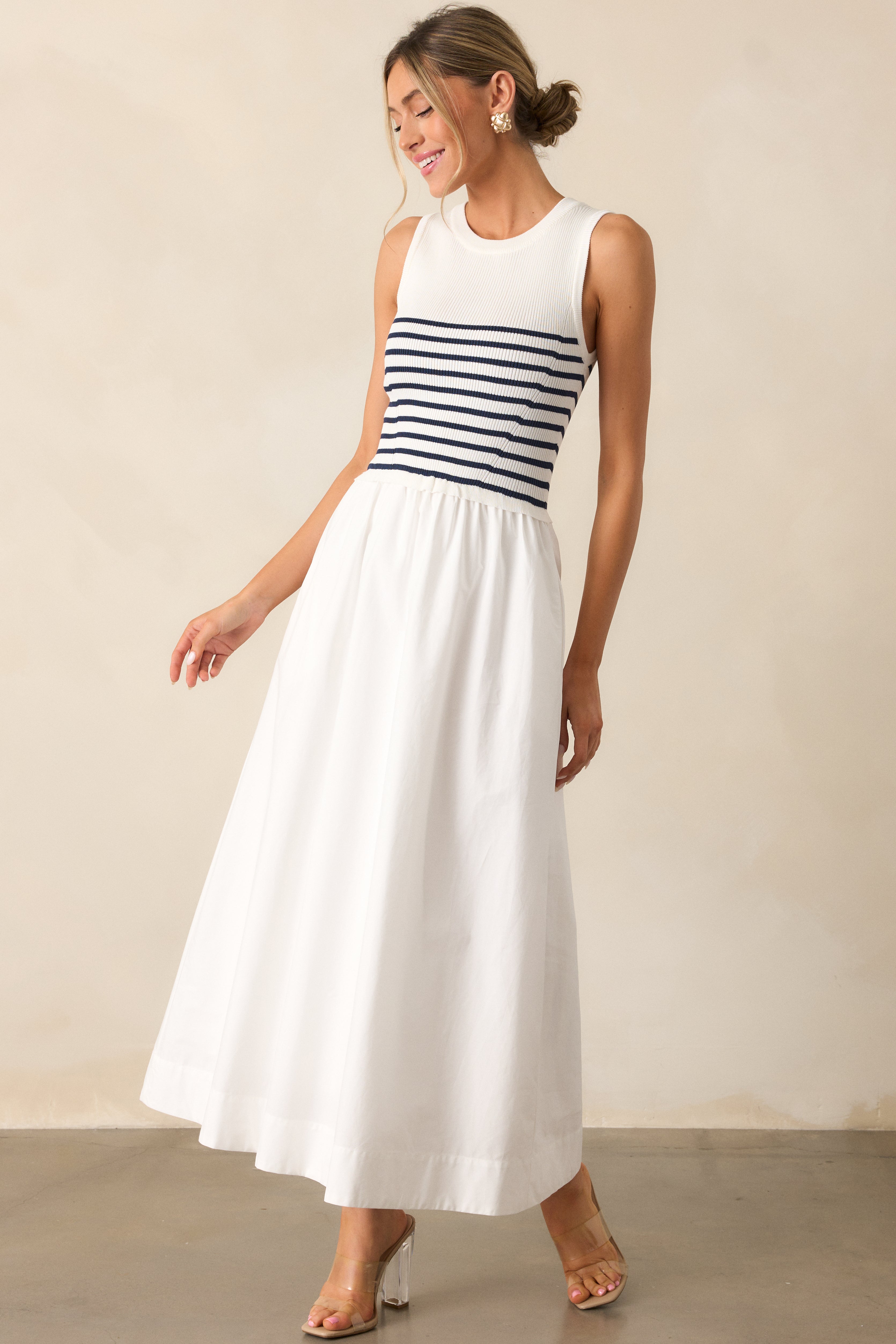 Angled view of the white stripe dress showing the clean lines of the fitted bodice and the casual stripe pattern.