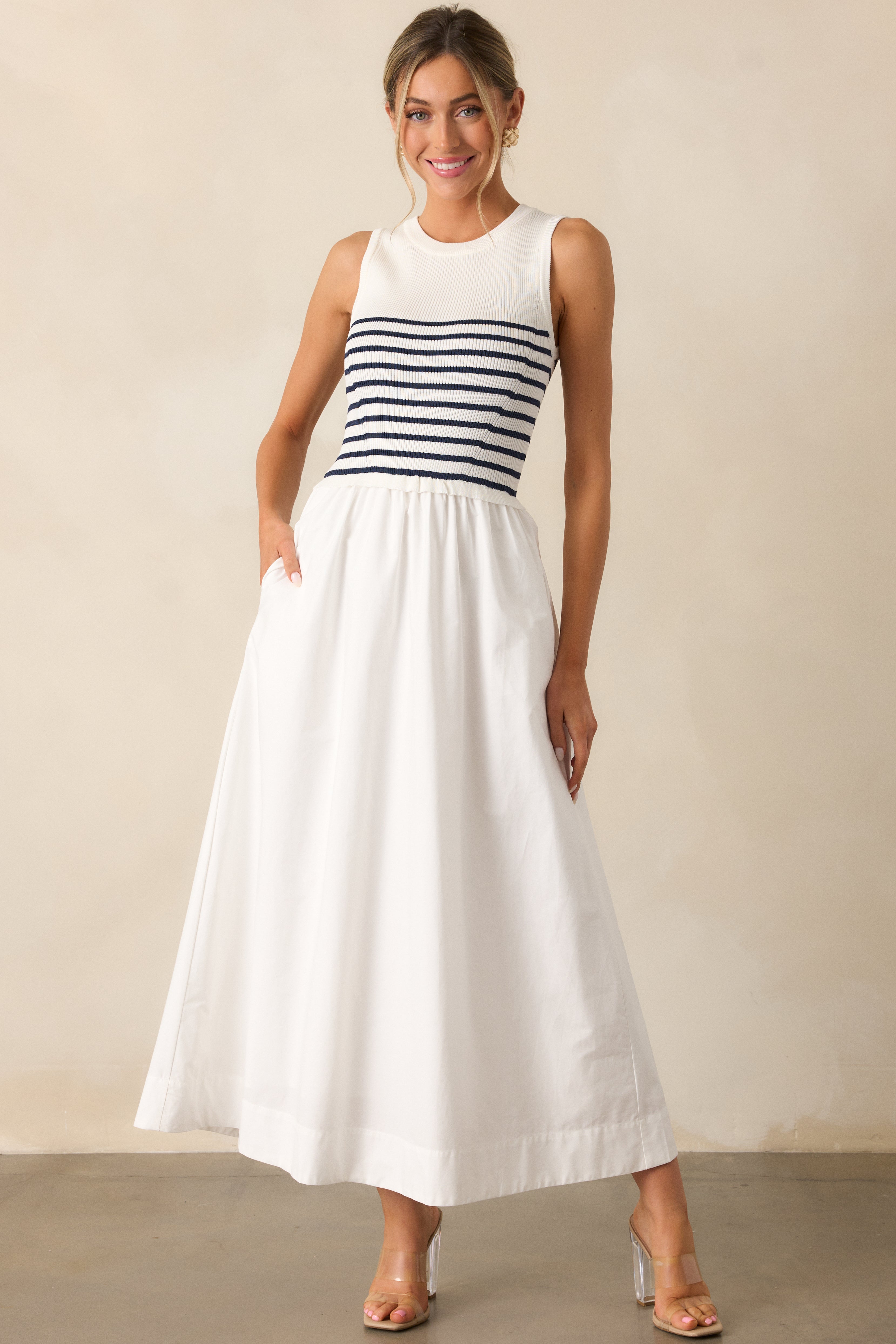 Another front-facing full shot of the white stripe dress, emphasizing the flattering fit and subtle pocket details.