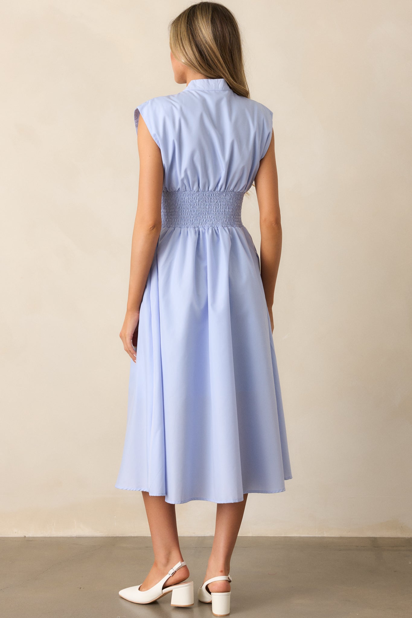 The back view of the baby blue midi dress, focusing on the smooth lines and sleek design, with a functional zipper closure and a simple, flattering shape.