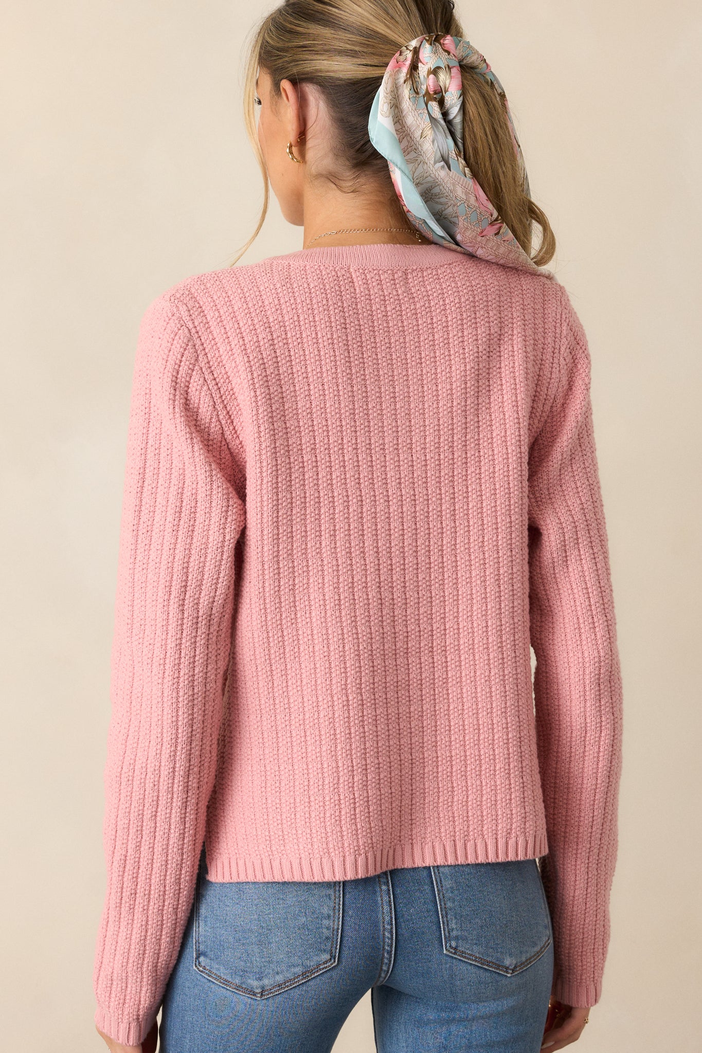 Rear view of the rose cardigan, showing the knit pattern and long-sleeved silhouette from the back.