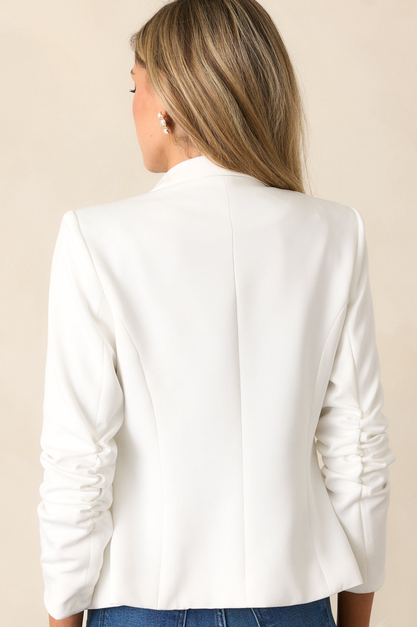 A back view of the blazer, showing the smooth tailored finish and clean seam lines.