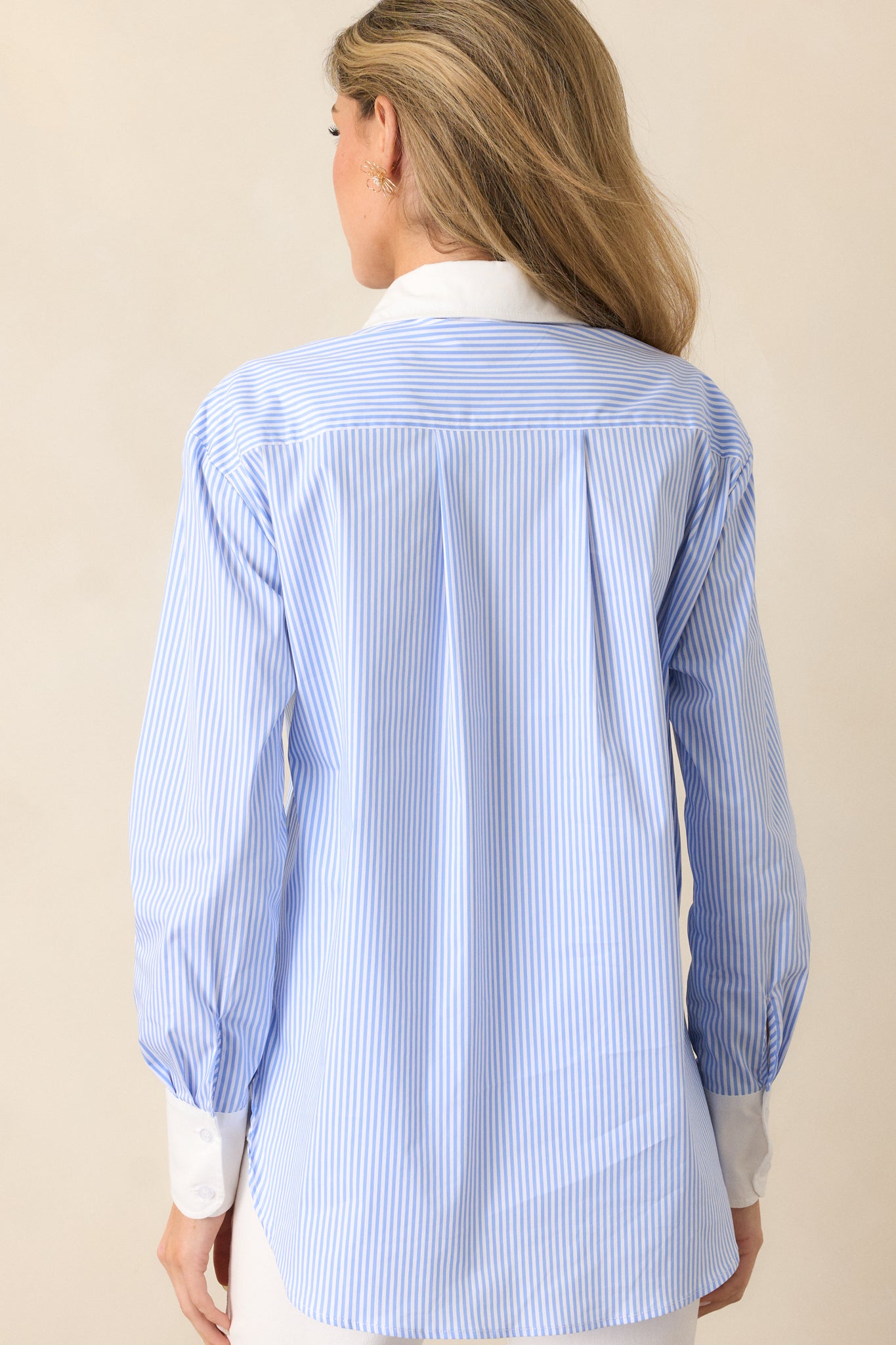 Back view of the blue stripe top, highlighting the seamless stripe pattern and tailored design.