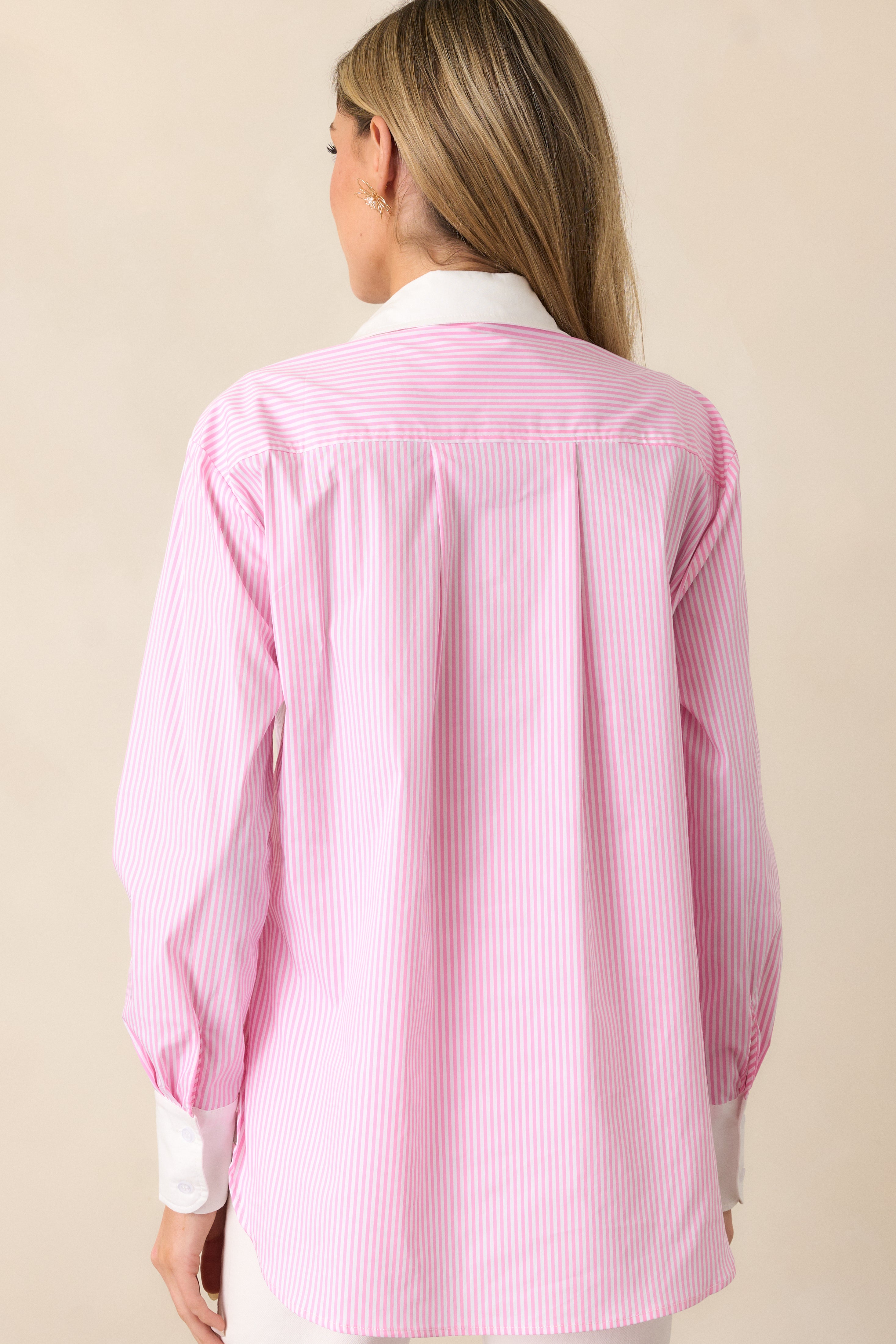 Back view of the pink stripe top, highlighting the seamless stripe pattern and tailored design.