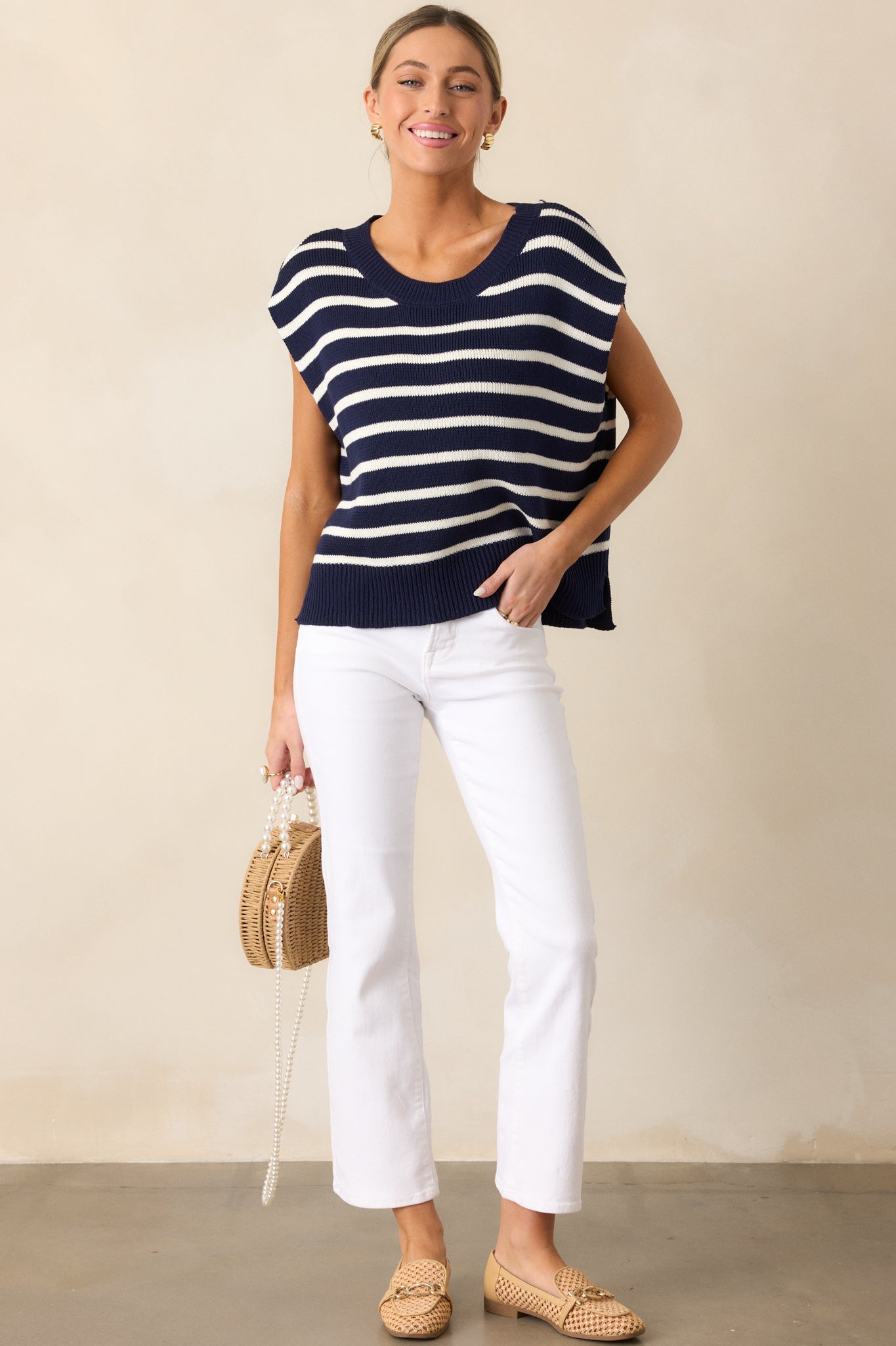  Navy sweater top showcasing horizontal stripes, a ribbed neckline, short sleeves, and a split hem detail at the sides.