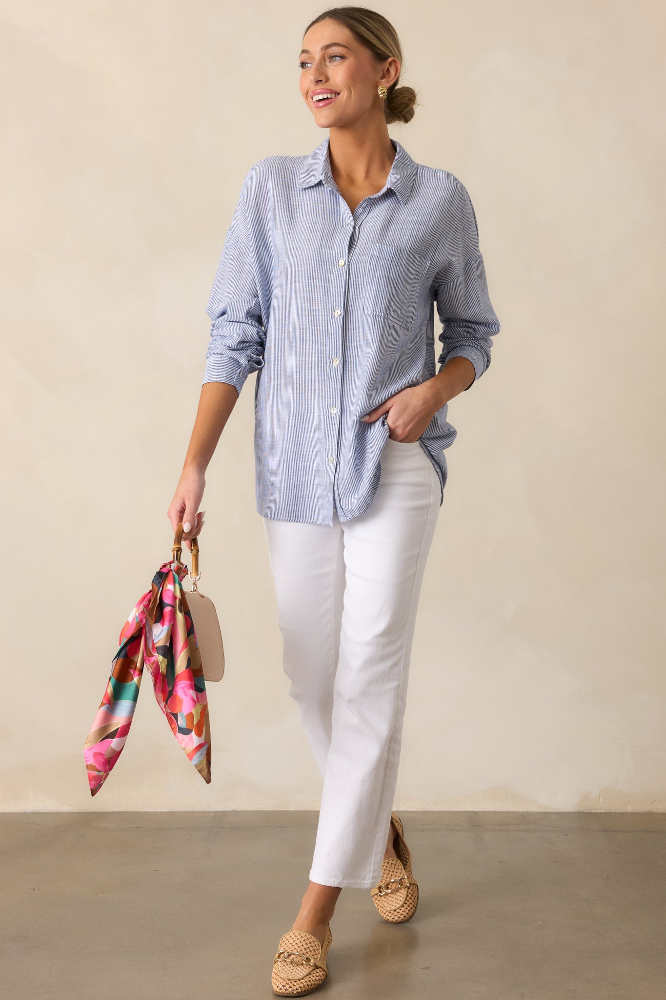 A front view of the stripe denim blouse, showcasing its collared neckline, button front design, relaxed fit, and long sleeves with cuffs.