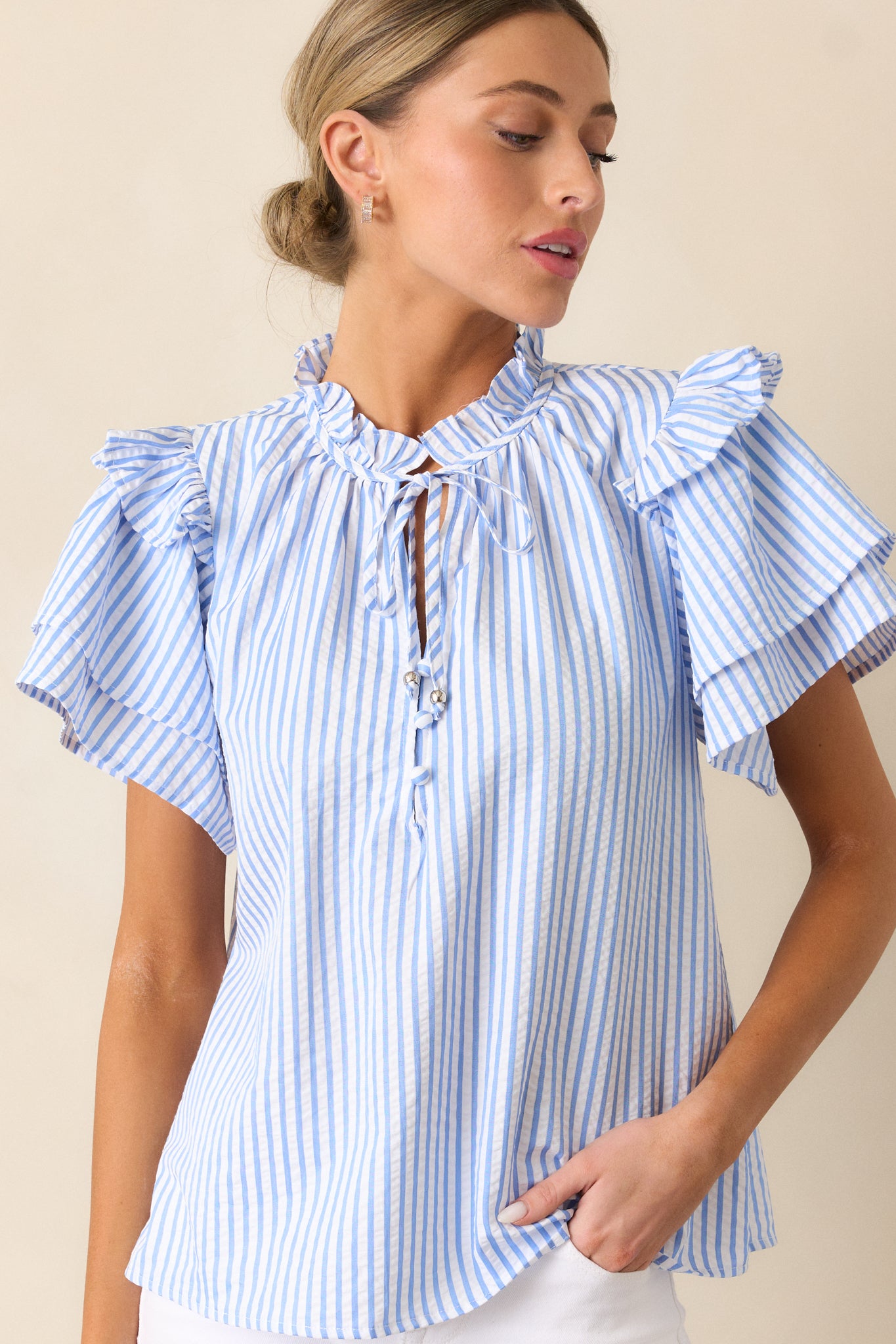 Close-up of the sleeve of the Blue Stripe Blouse emphasizing the double-tiered ruffle and vertical stripe pattern.