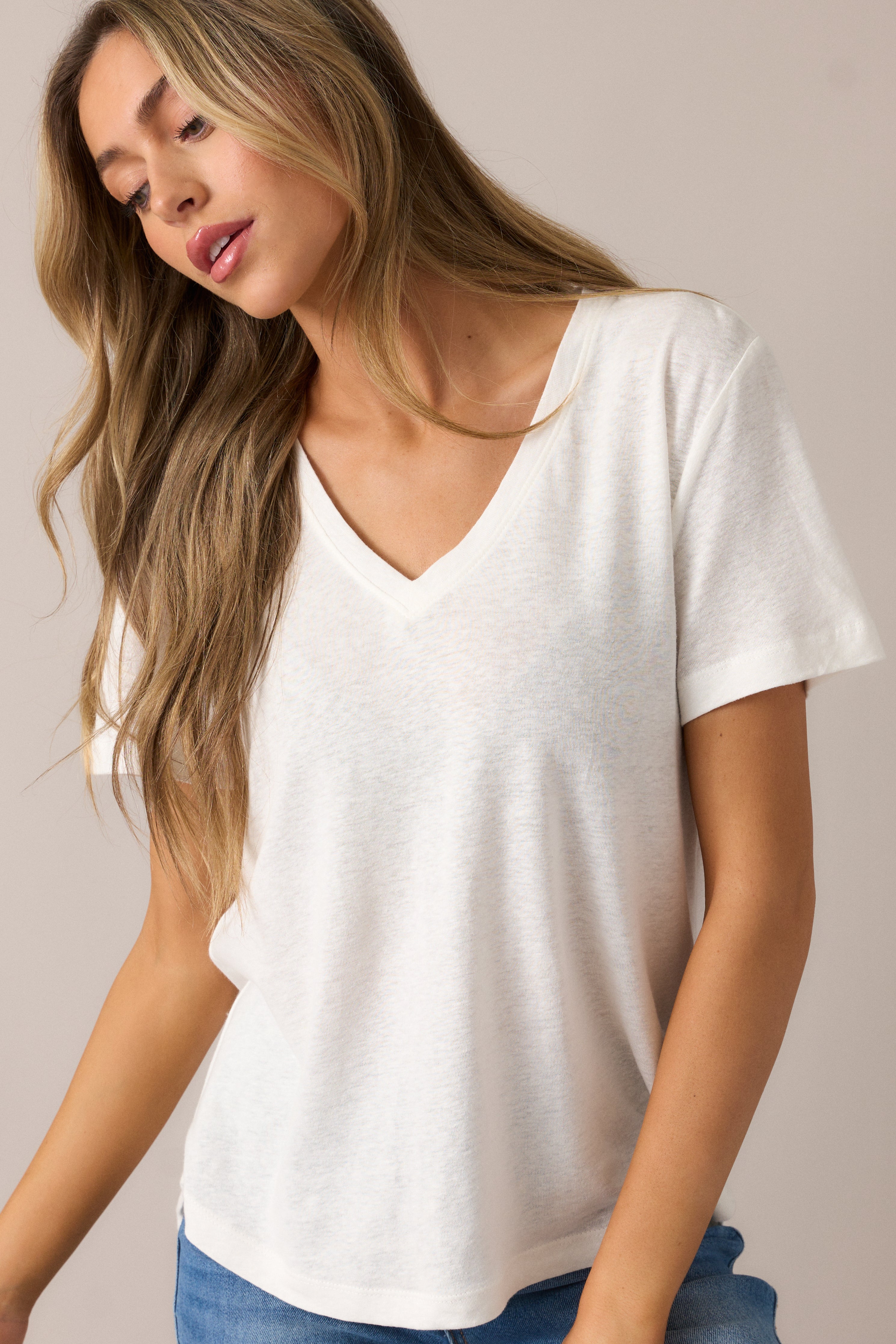 A closer look at the short sleeves and the delicate texture of the washed ivory fabric.