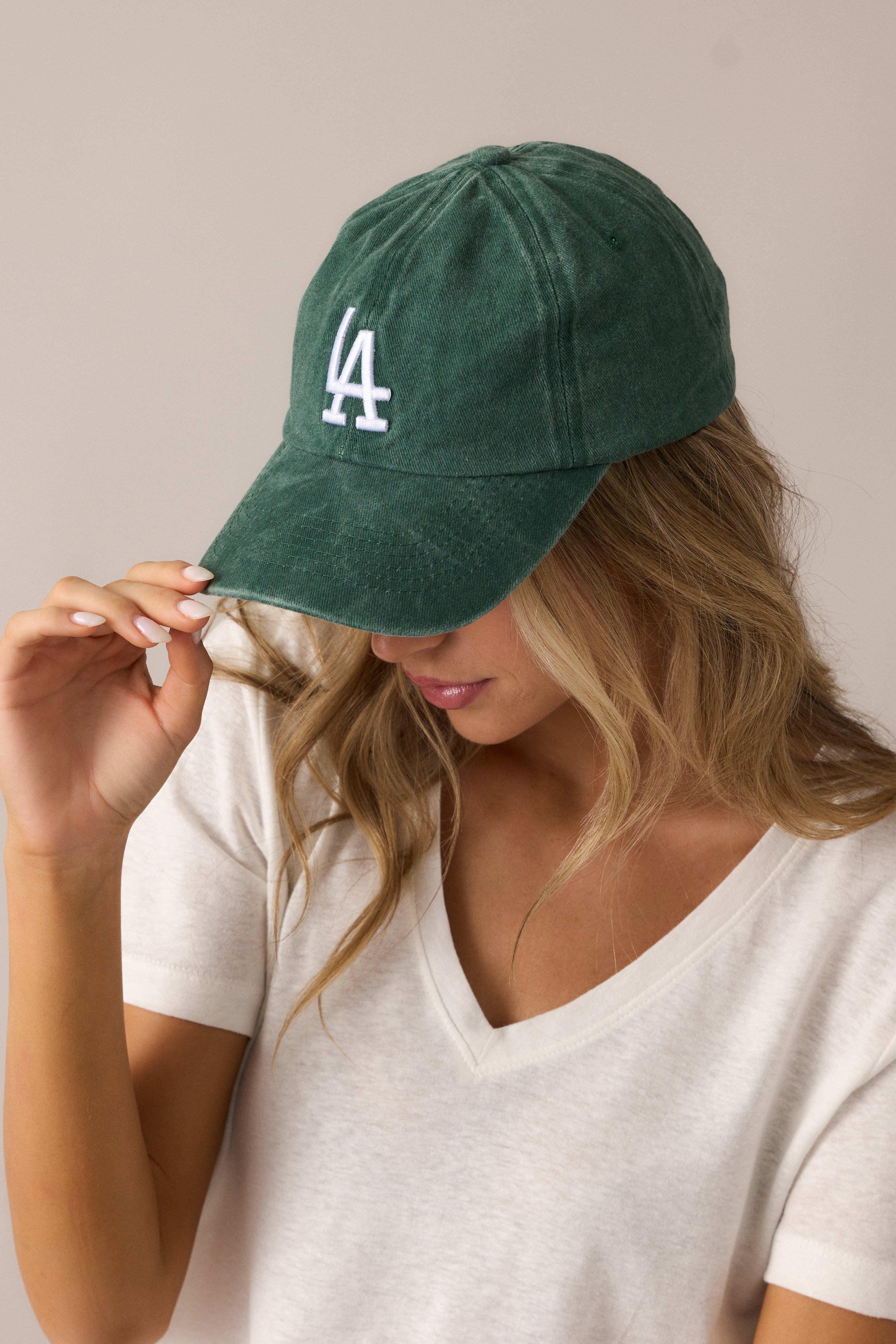 Emerald hat showcasing its timeless baseball cap silhouette, soft material, and striking white LA logo embroidery.