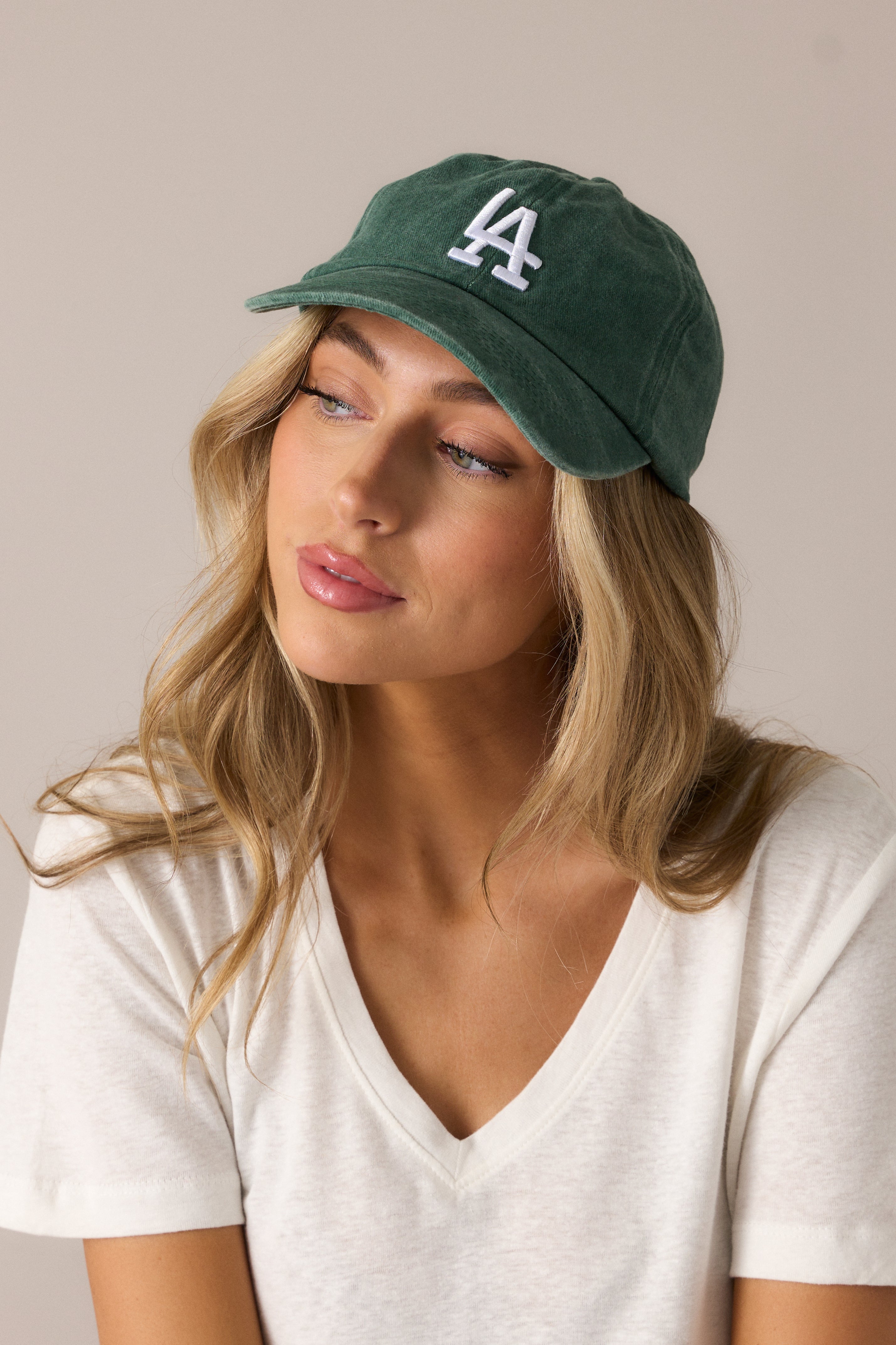  Emerald baseball cap with a bold embroidered LA logo in white, styled in a classic design with a relaxed fit.