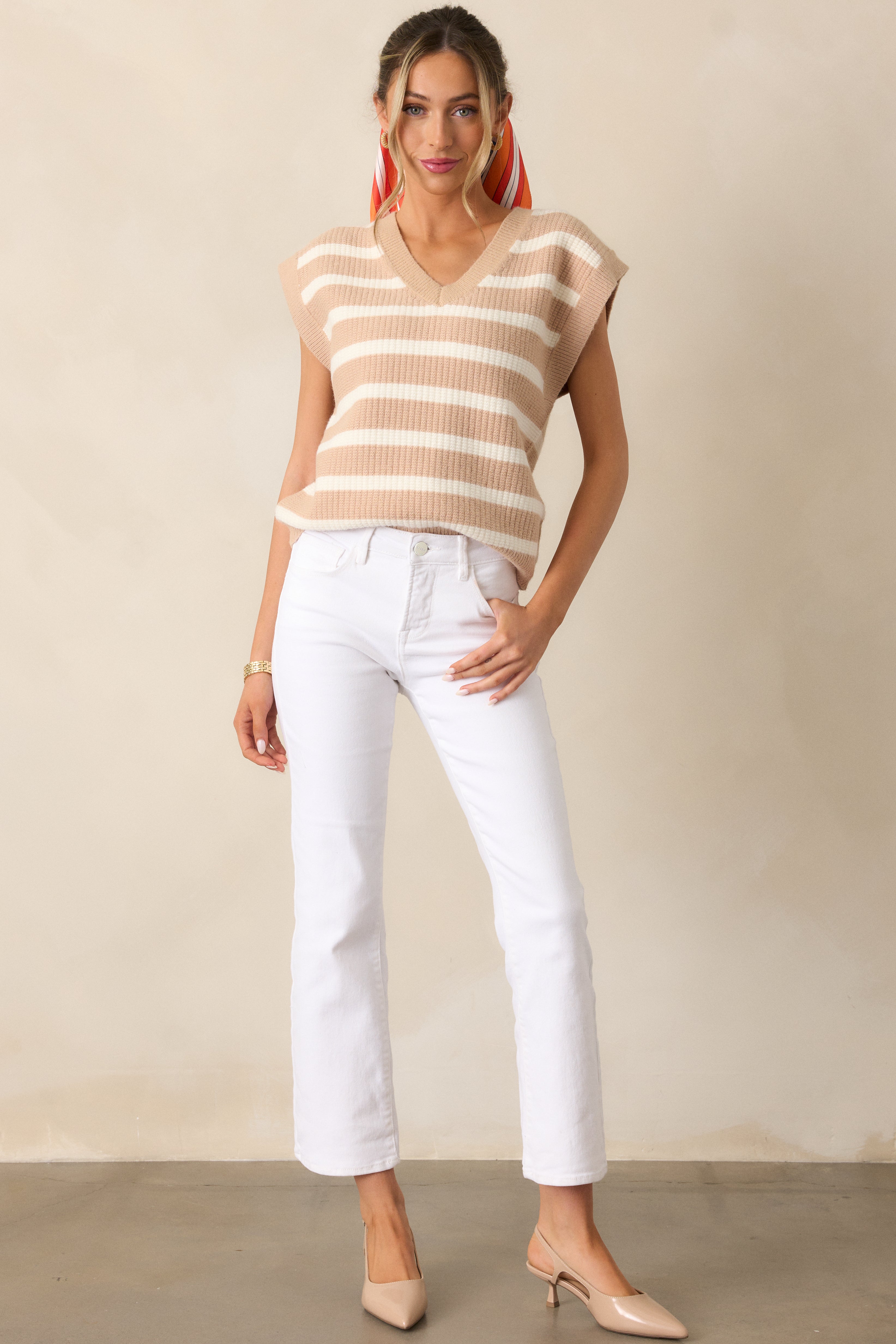 Chic white jeans featuring a high waist, button-zipper closure, and functional hip and back pockets, designed for a sleek, modern silhouette with a straight leg fit.