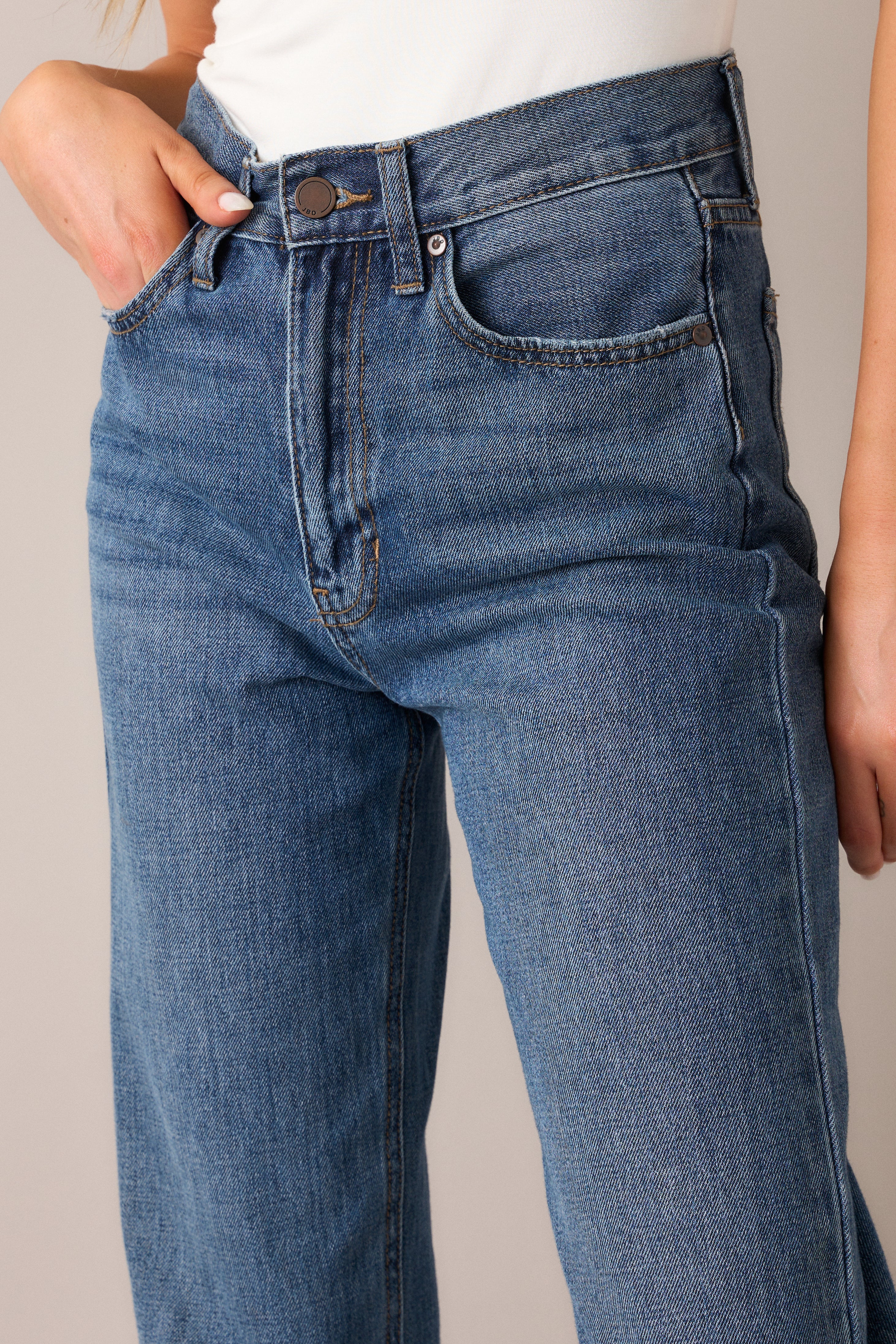 A detailed view of the seam detailing and functional pockets, emphasizing the craftsmanship and practical design of these classic straight-leg jeans.