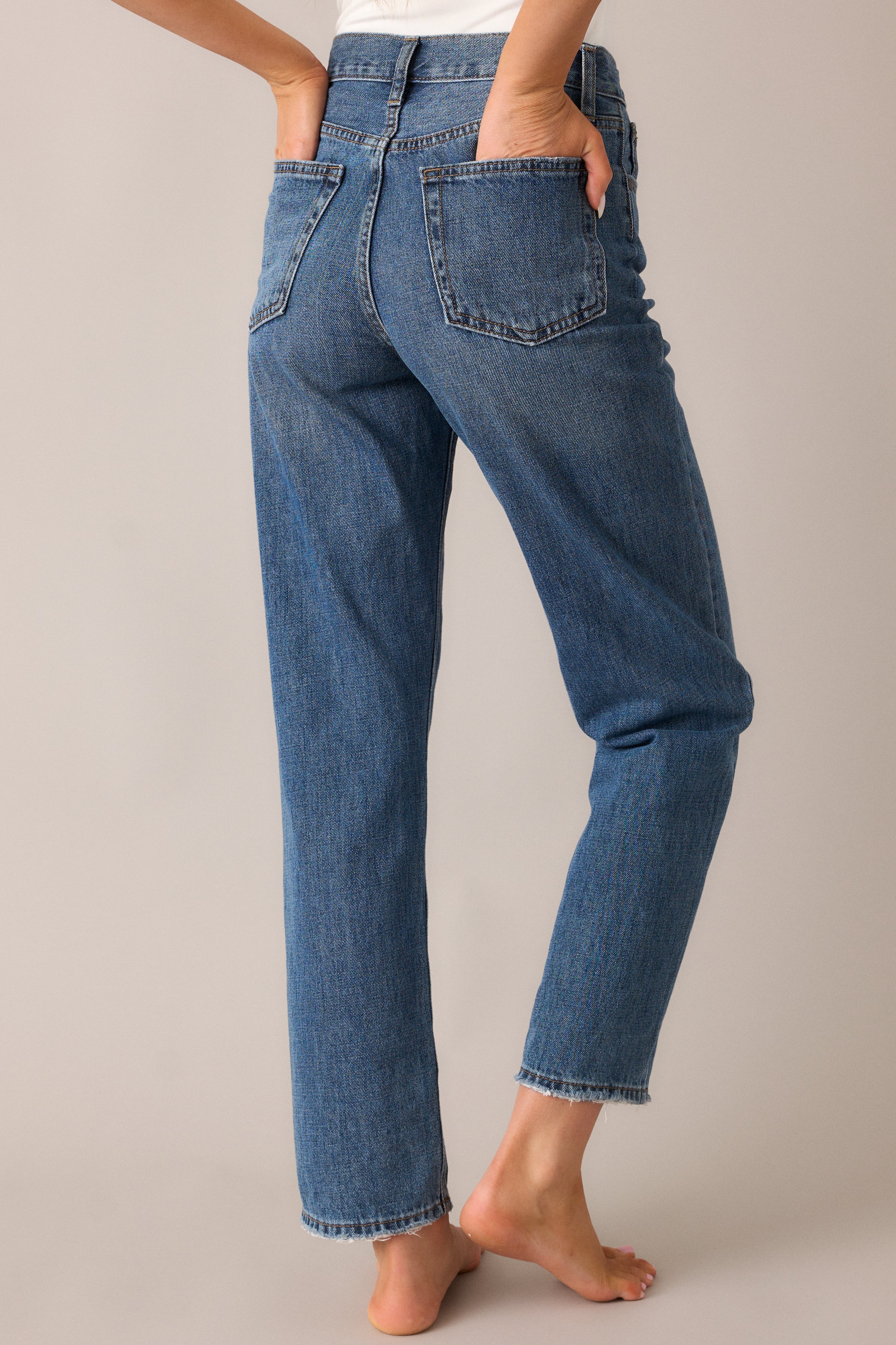  The jeans from the back, highlighting the straight-leg cut, functional pockets, and the subtle seam detailing that provides a flattering, streamlined look.