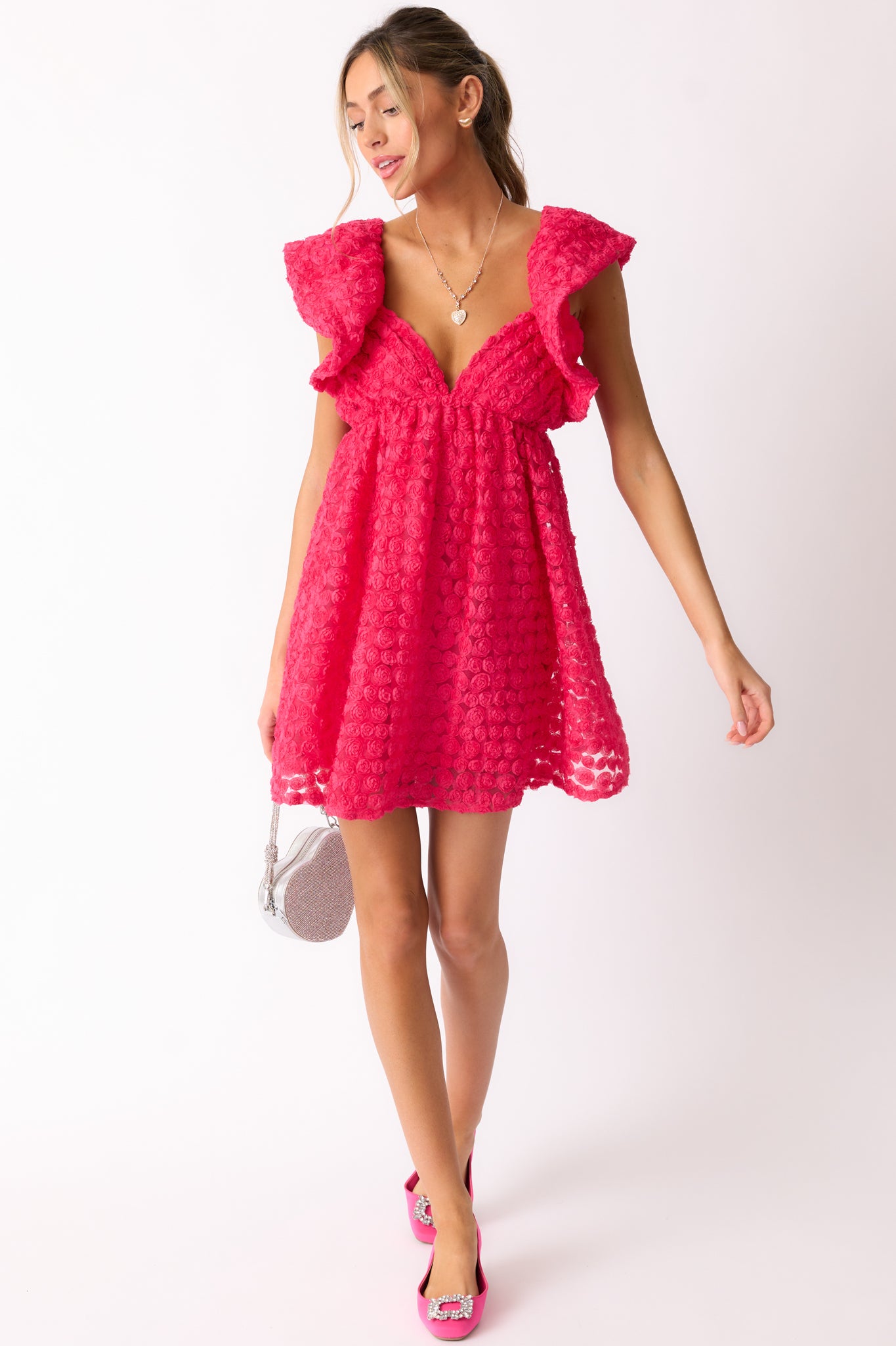 A complete look of the hot pink mini dress, highlighting the delicate flutter sleeves and textured fabric details.