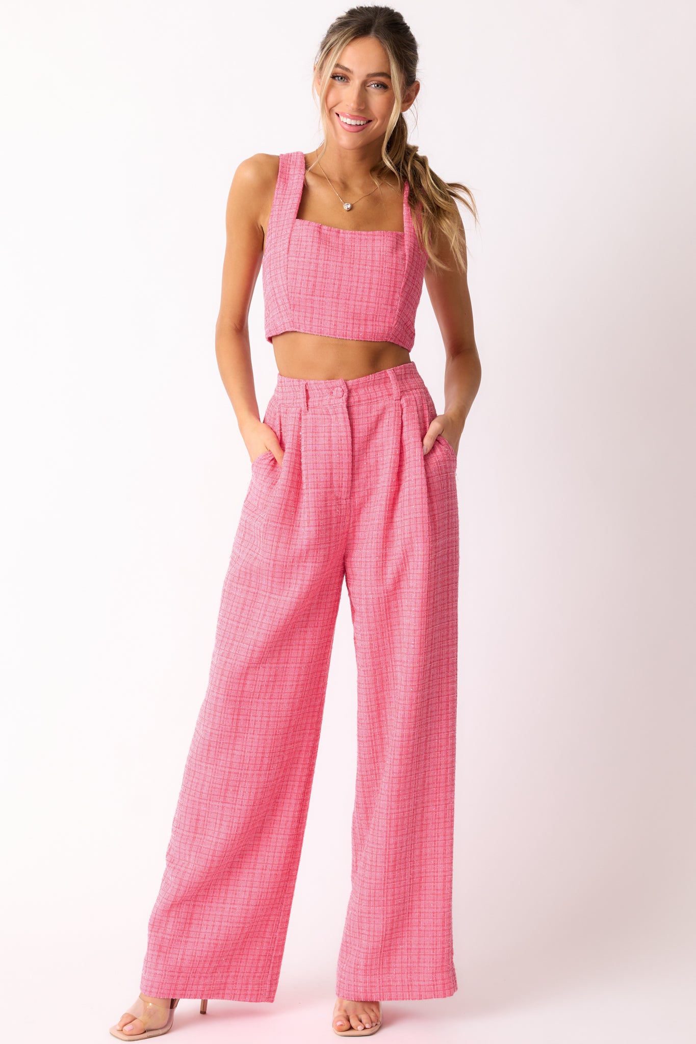 A complete look of the pink tweed pants highlighting the functional belt loops, pockets, and the flow of the wide leg design.