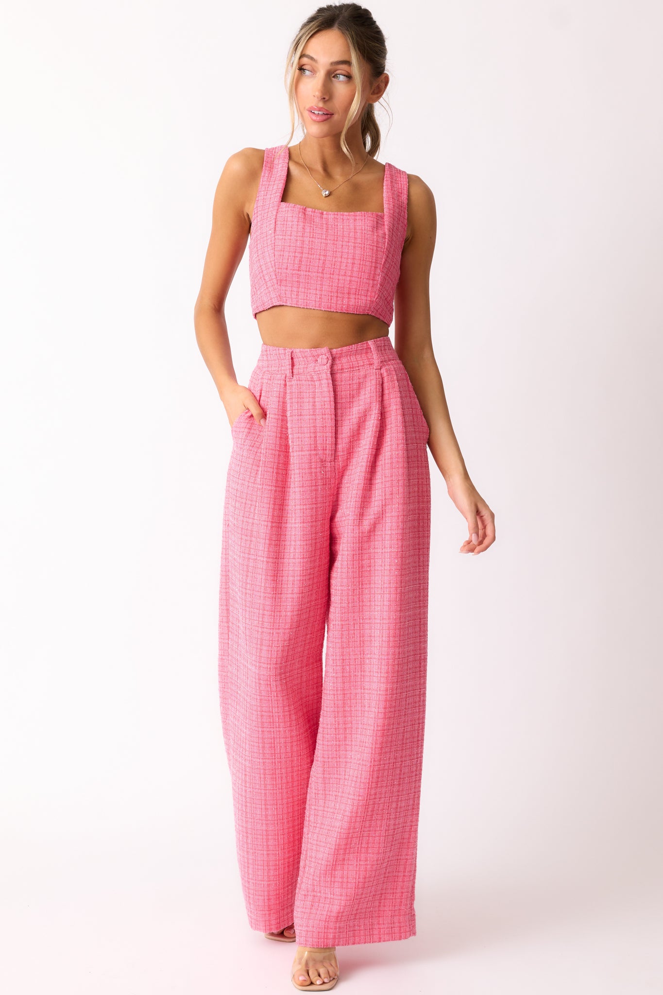 A front view of the pink pants showcasing the high waist design, shimmery tweed fabric, and wide leg cut.