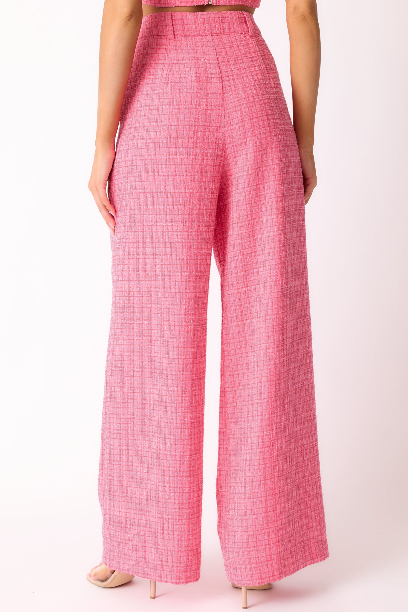 A back view of the pink pants, showing the high waist design, seamless stitching and fabric, and the flow of the wide leg cut.