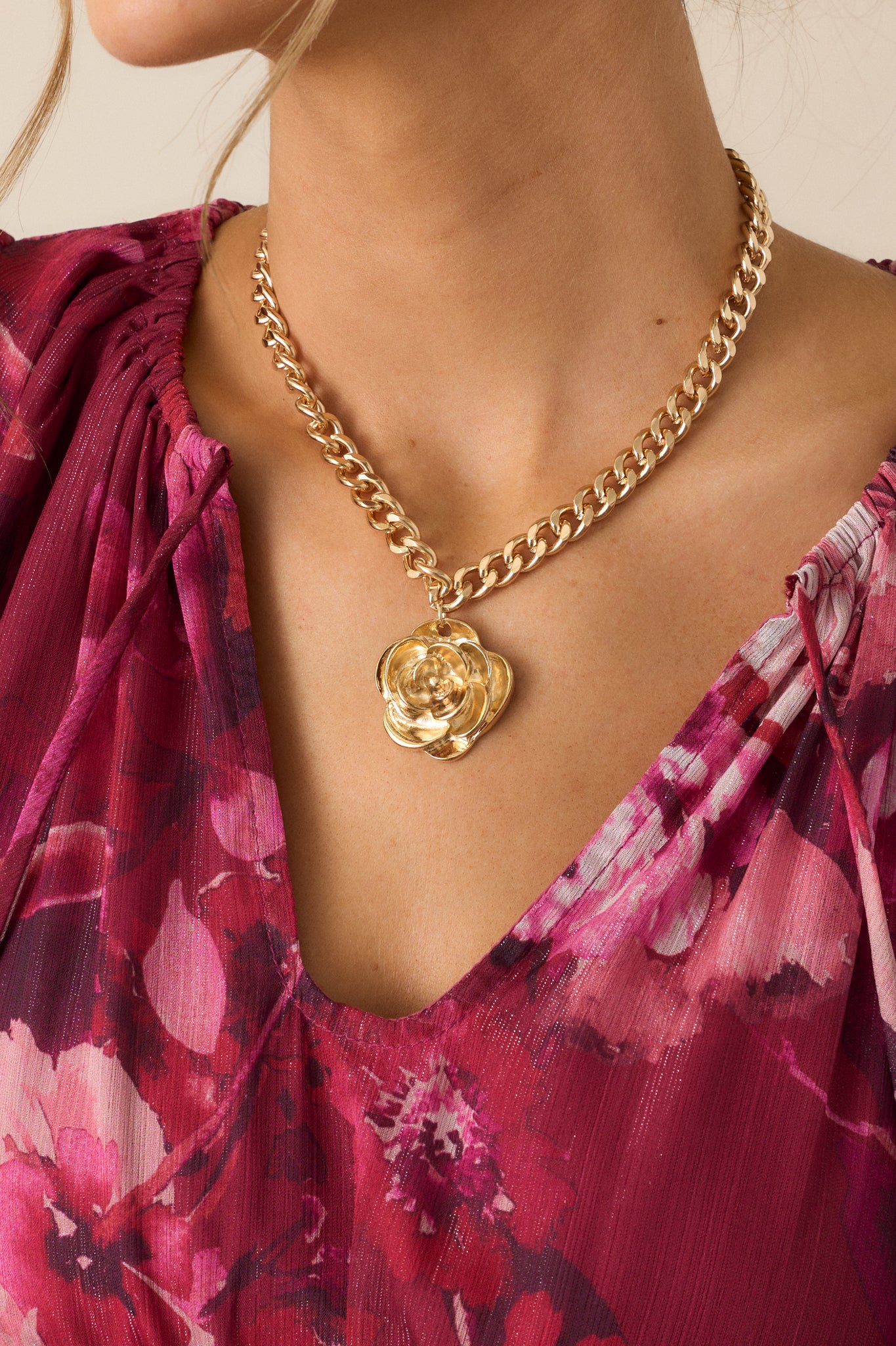 A detailed shot focusing on the large textured rose pendant, showcasing its dimensional design and intricate texture.