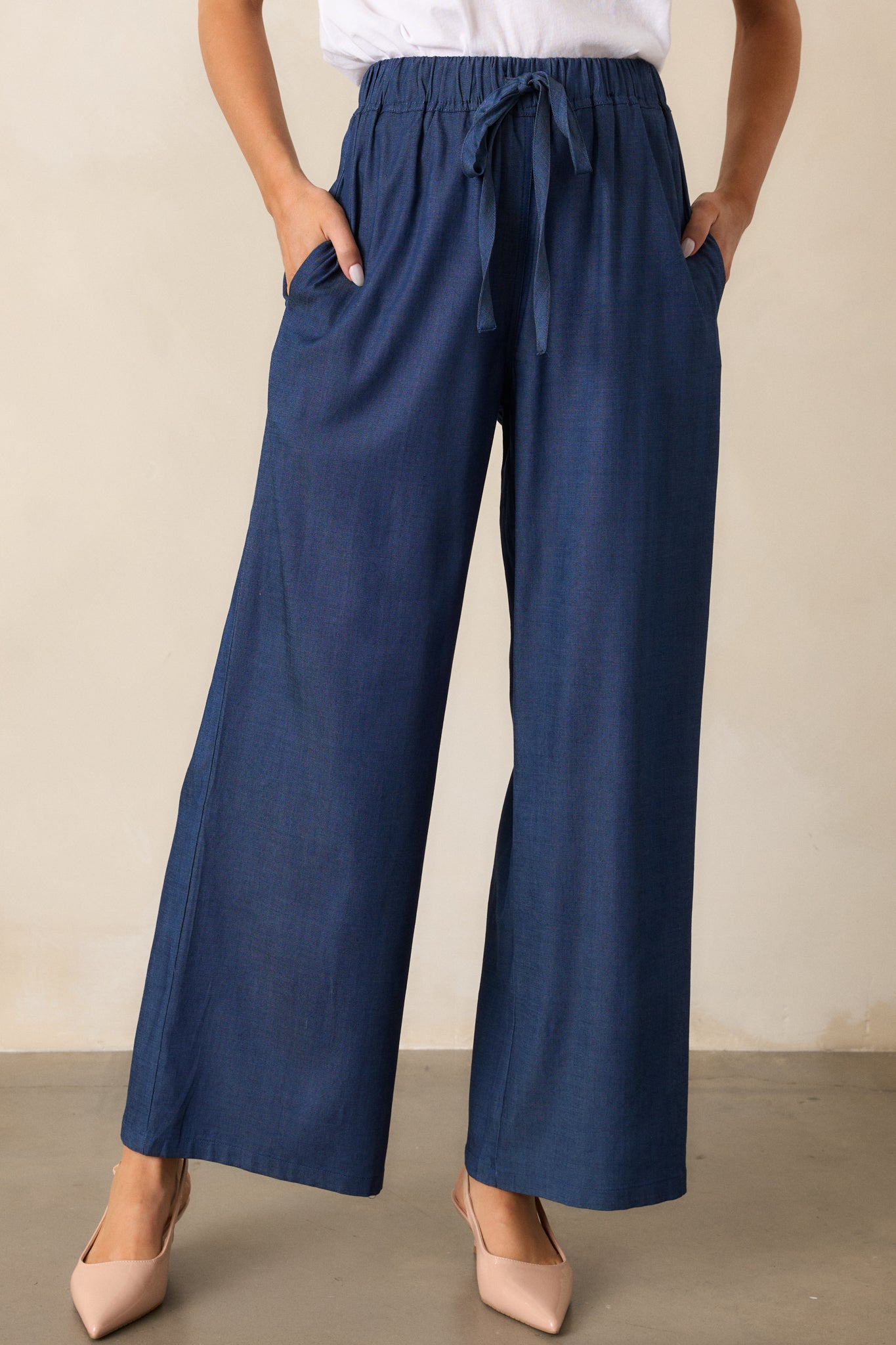 A detailed close-up of the pants’ waistband and self-tie drawstring, highlighting the texture of the chambray material.