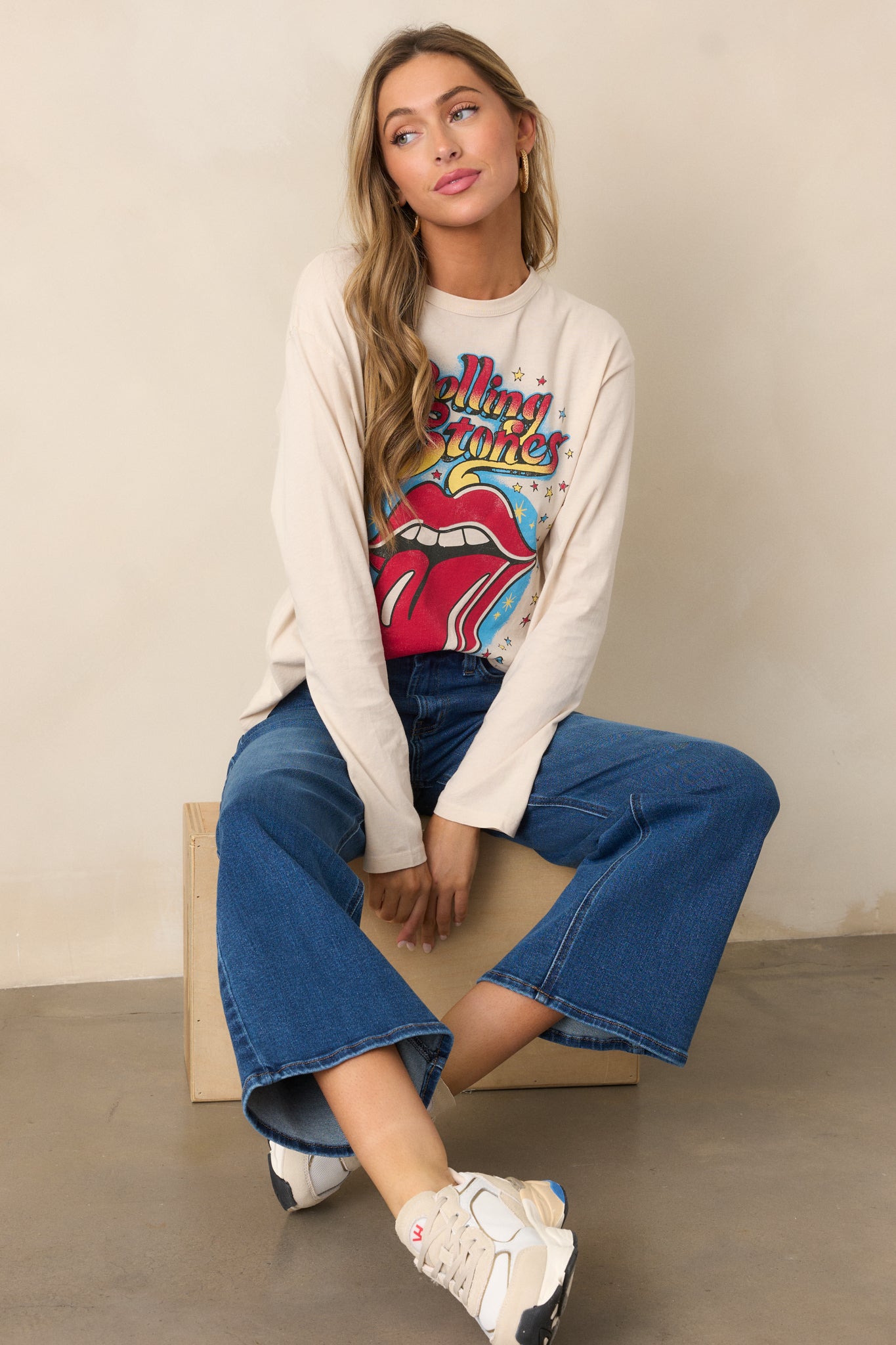 A casual ecru long sleeve tee with a crew neckline, showcasing a bold Rolling Stones 1972 Tour graphic and a laid-back silhouette.

