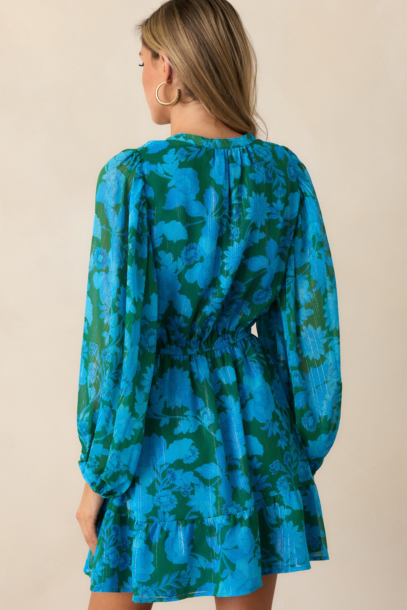 A back view of the blue mini dress, focusing on the relaxed fit and tiered skirt.