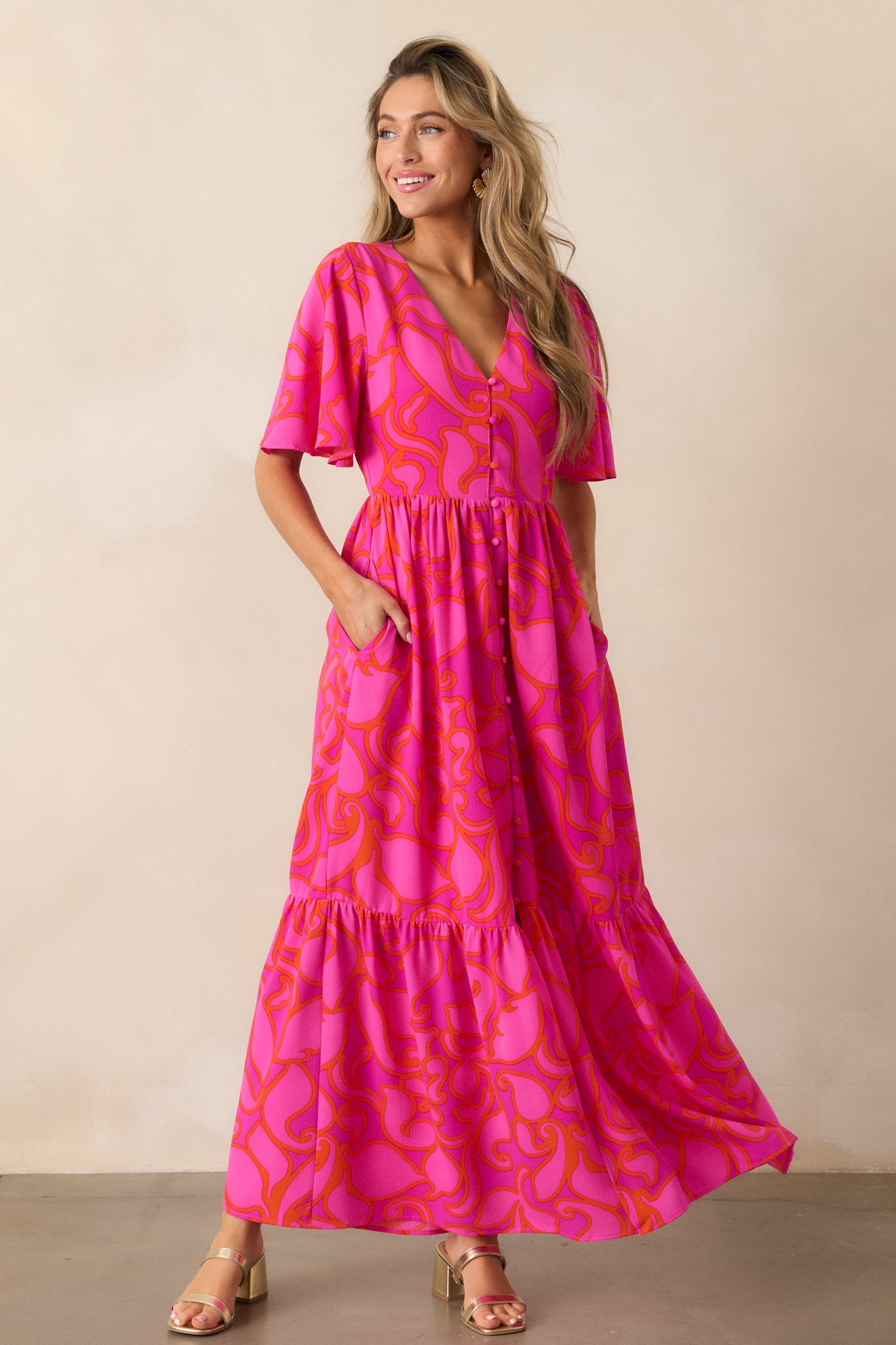 Full-length image of the magenta maxi dress, highlighting its functional button front, tiered skirt, and hidden functional pockets seamlessly integrated into the design.