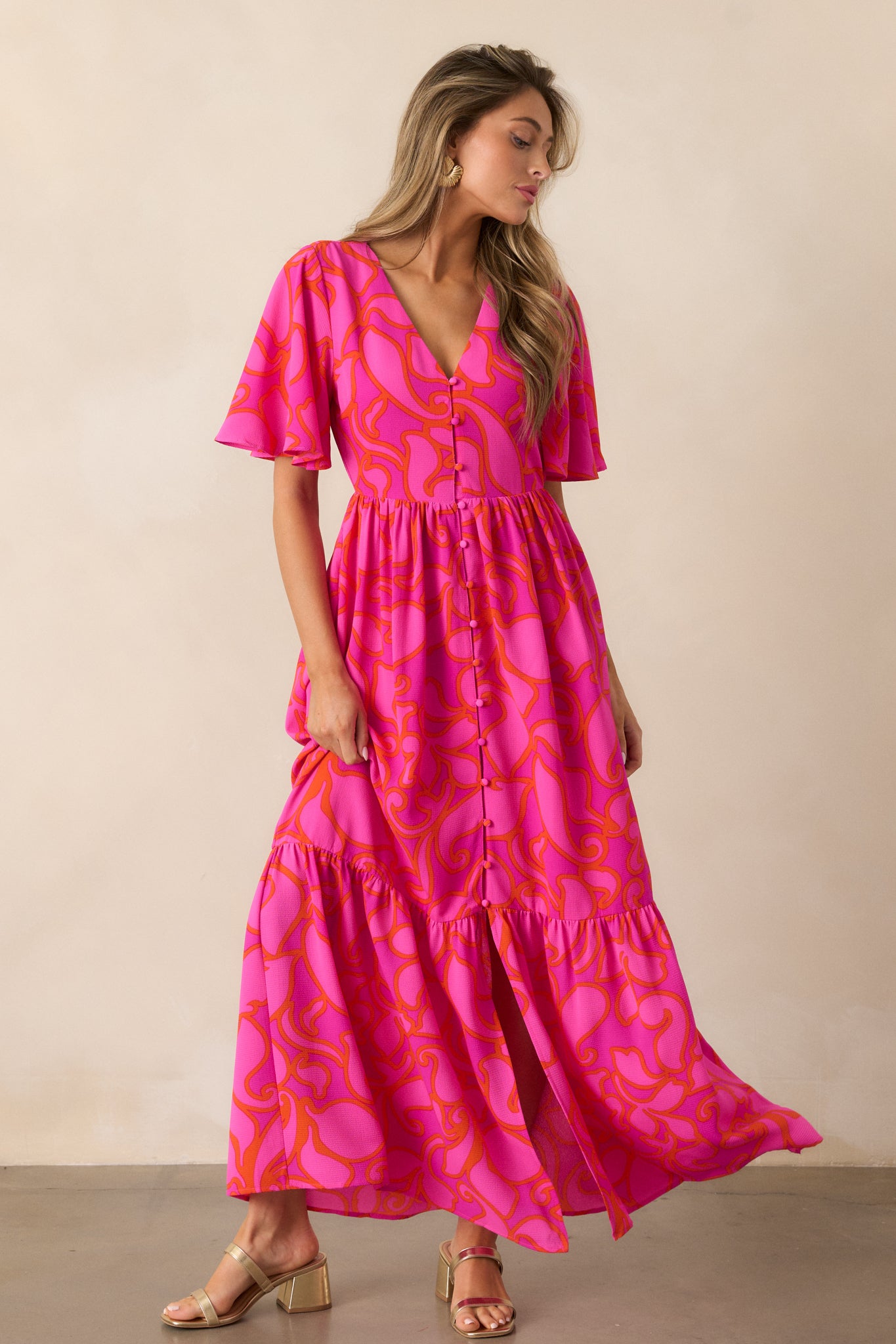 Full-length image of the magenta maxi dress, emphasizing the functional button front and the elegant, layered design of the skirt.