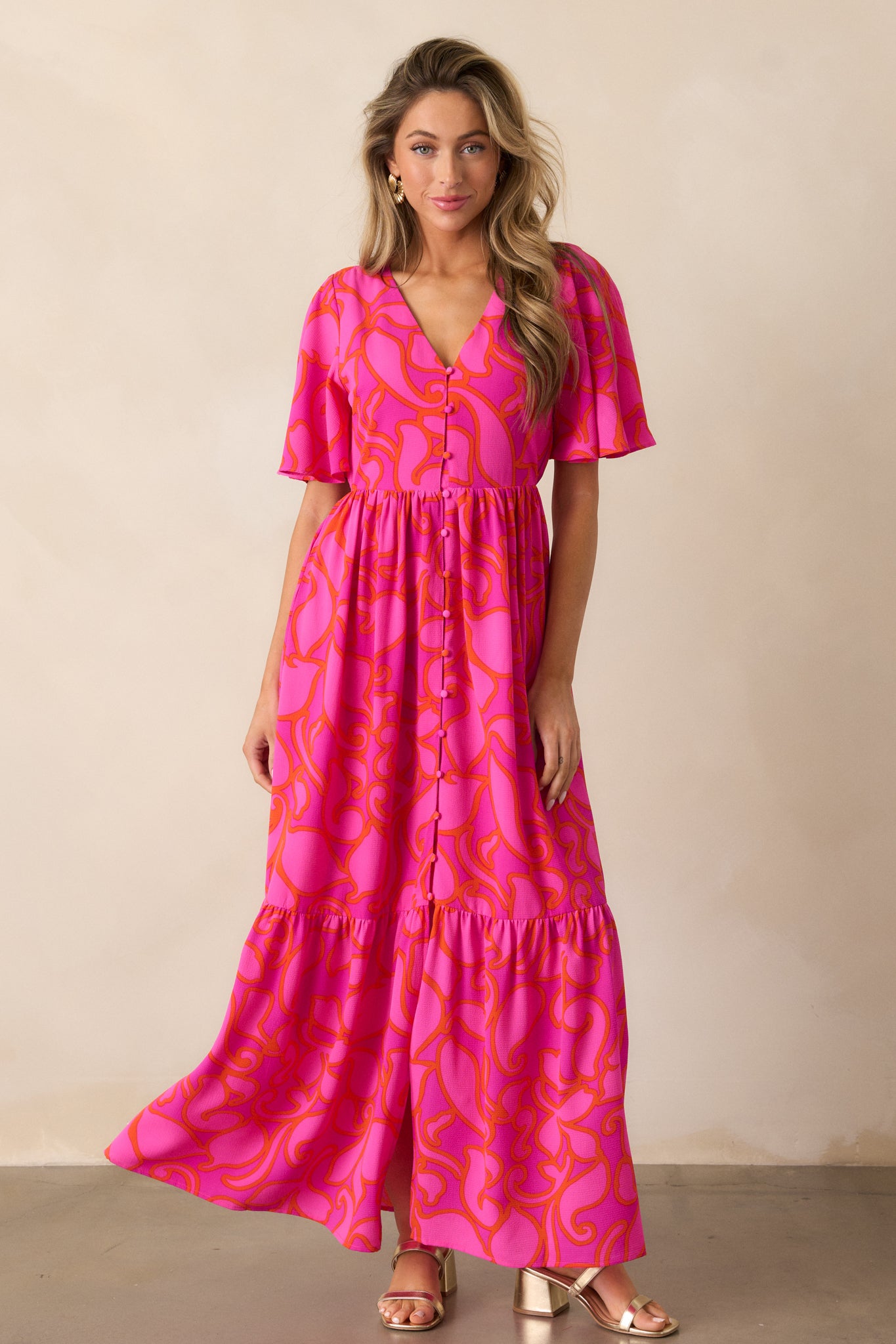 Full-length view of the maxi dress, focusing on the soft drape of the flowy short sleeves and structured tiered skirt.