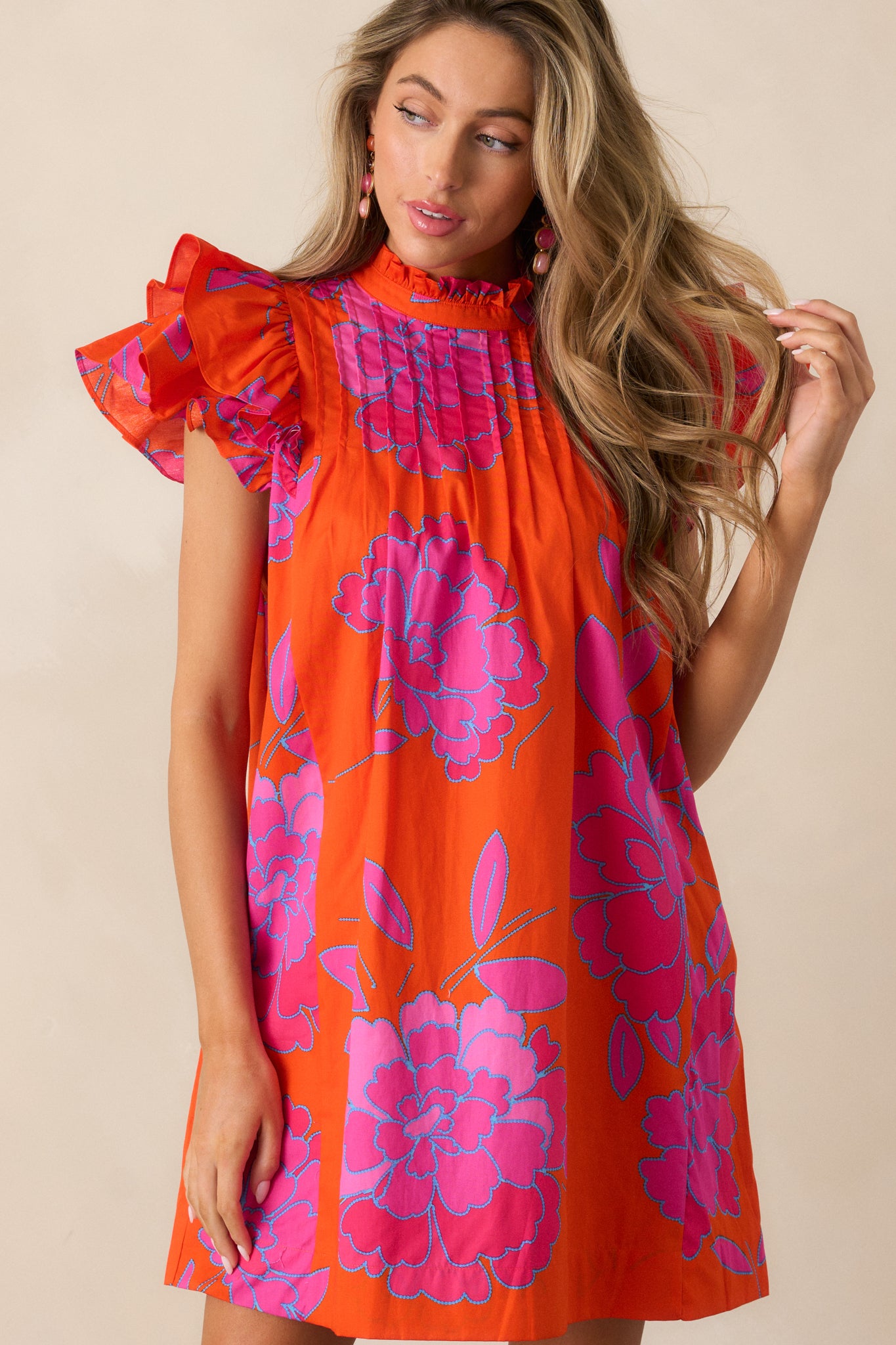  Cropped image focusing on the double flutter sleeves and how they flow against the vibrant fabric.