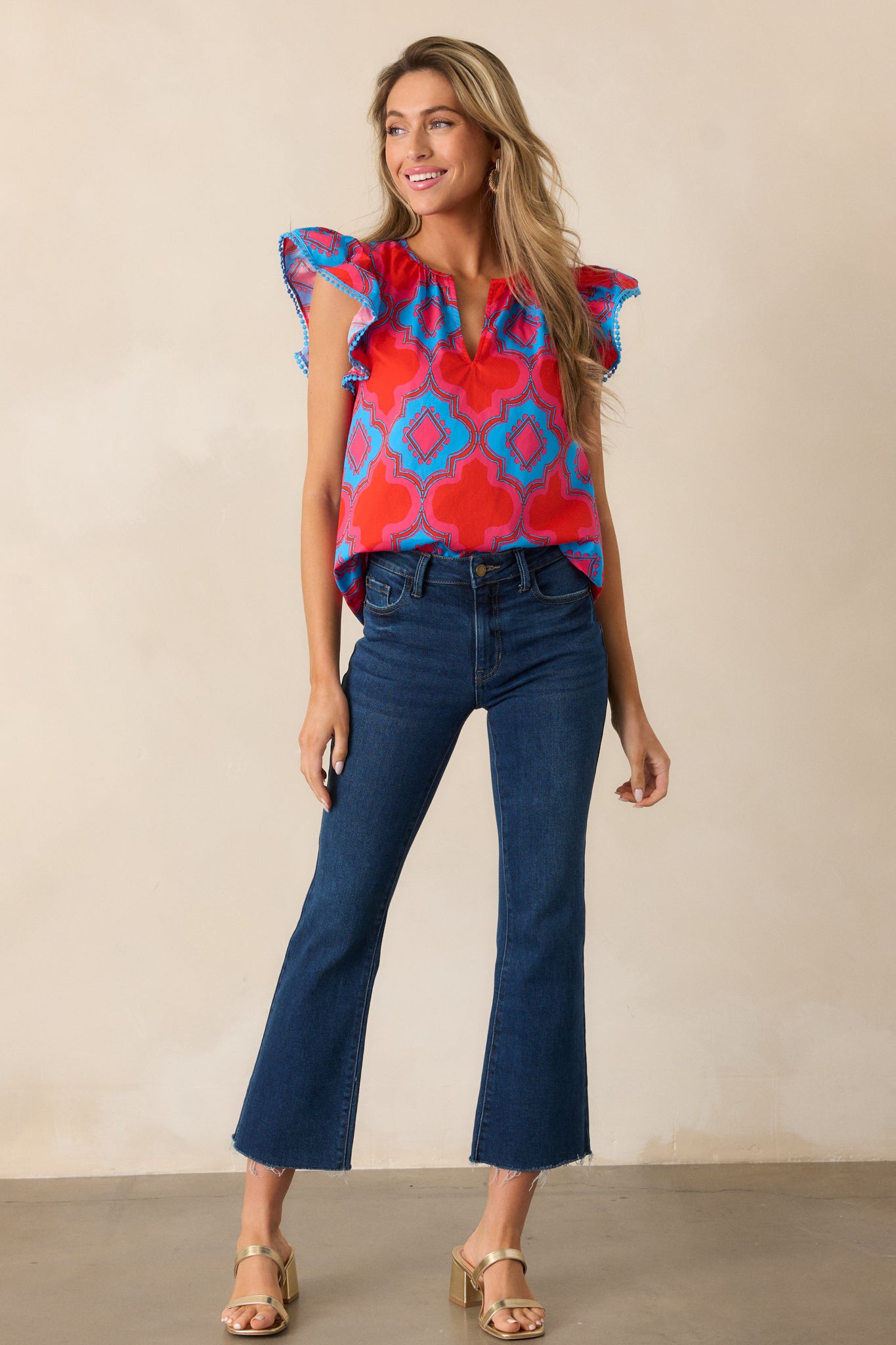 Full-length image of the red top, highlighting the relaxed fit and the soft, flowing silhouette with flutter sleeves.