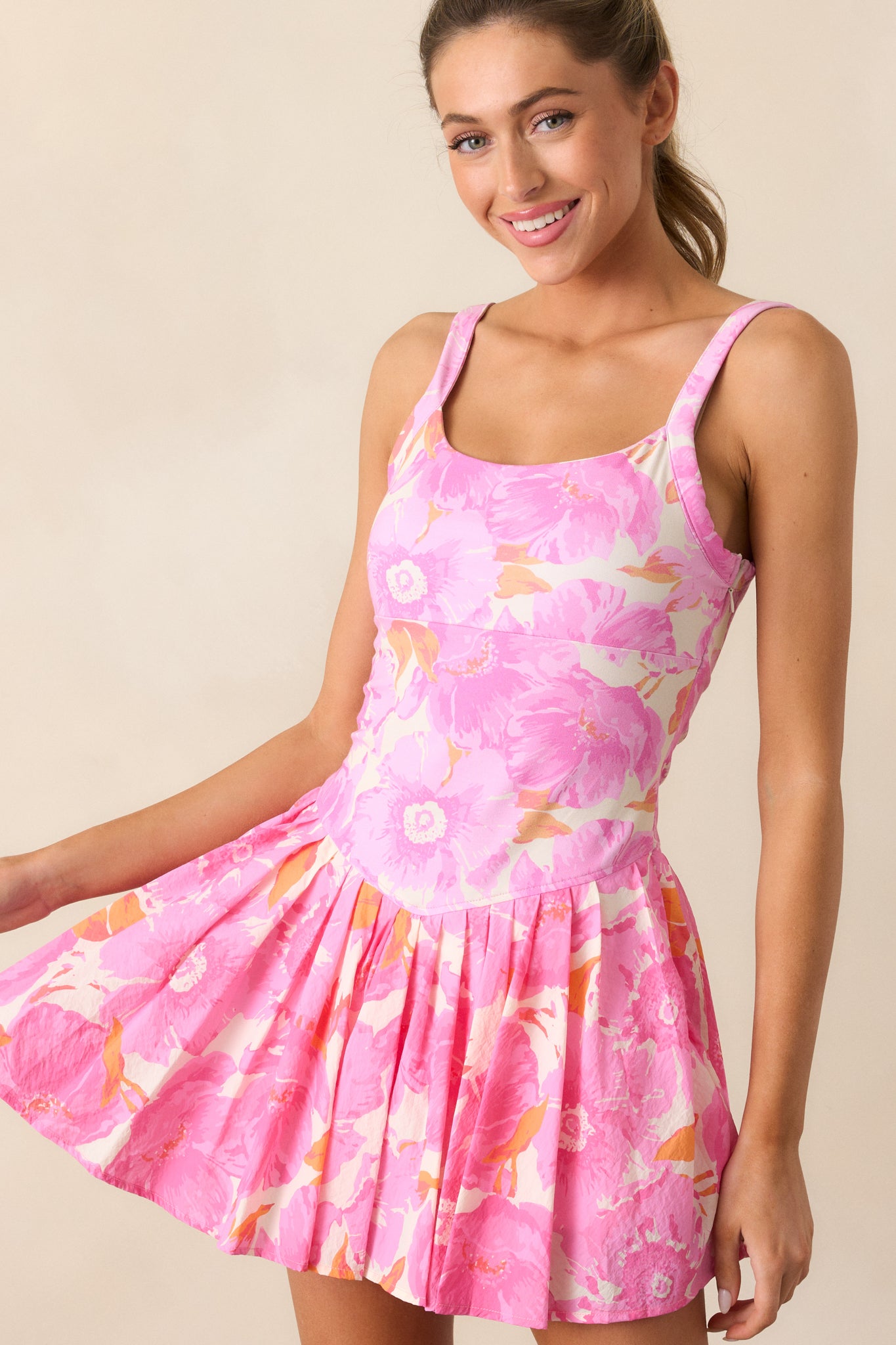 A view highlighting the pastel floral pattern and thin straps of the mini dress, showcasing its delicate design.