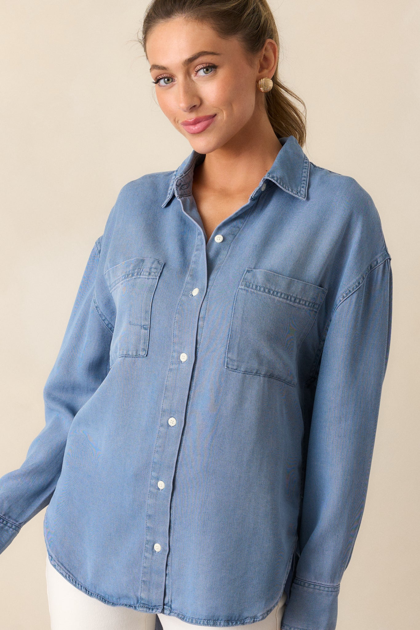 Detailed view of the long sleeves and collared neckline on the chambray top.