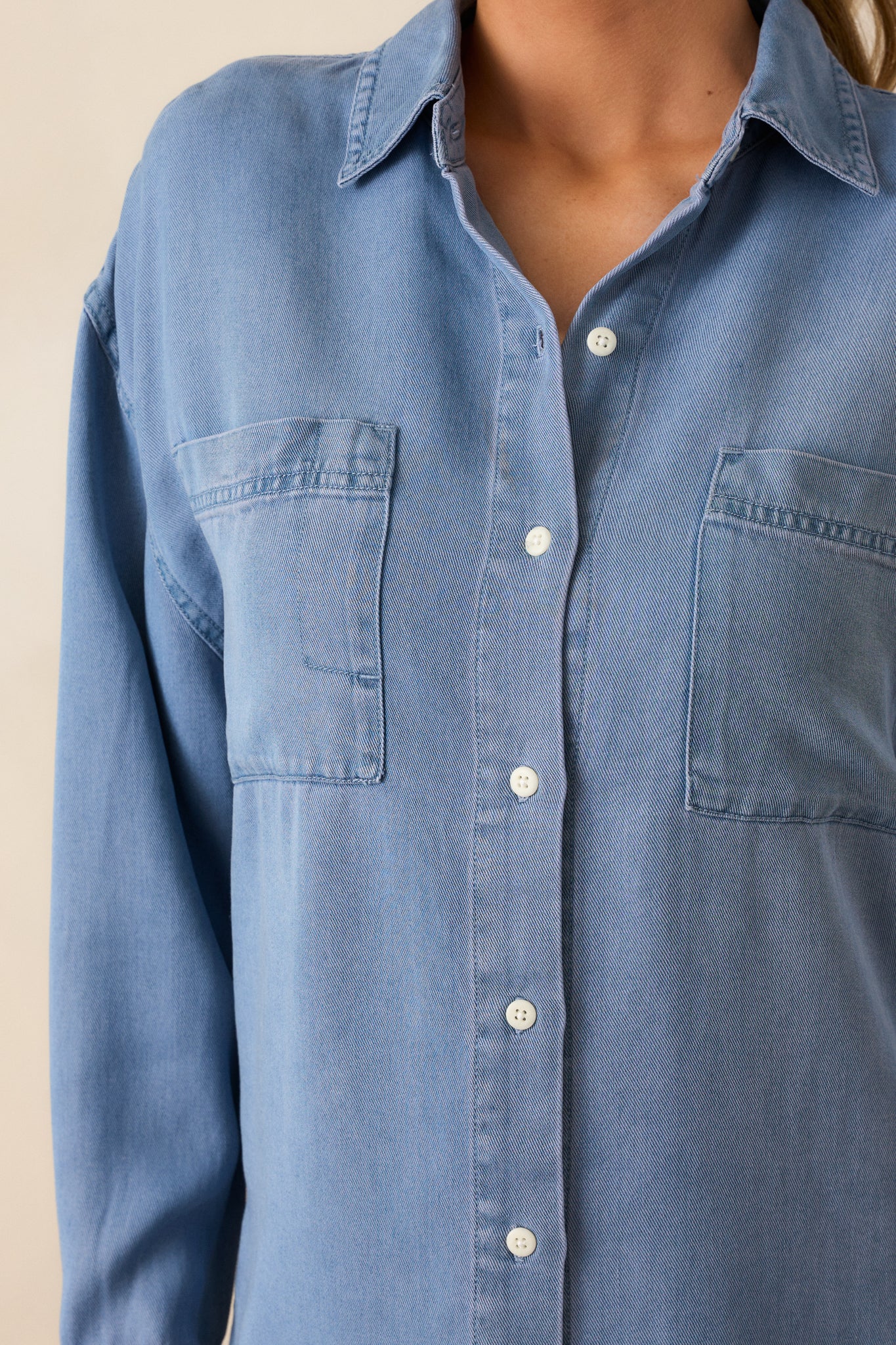 An up-close shot of the chambray top’s button front and functional chest pockets.