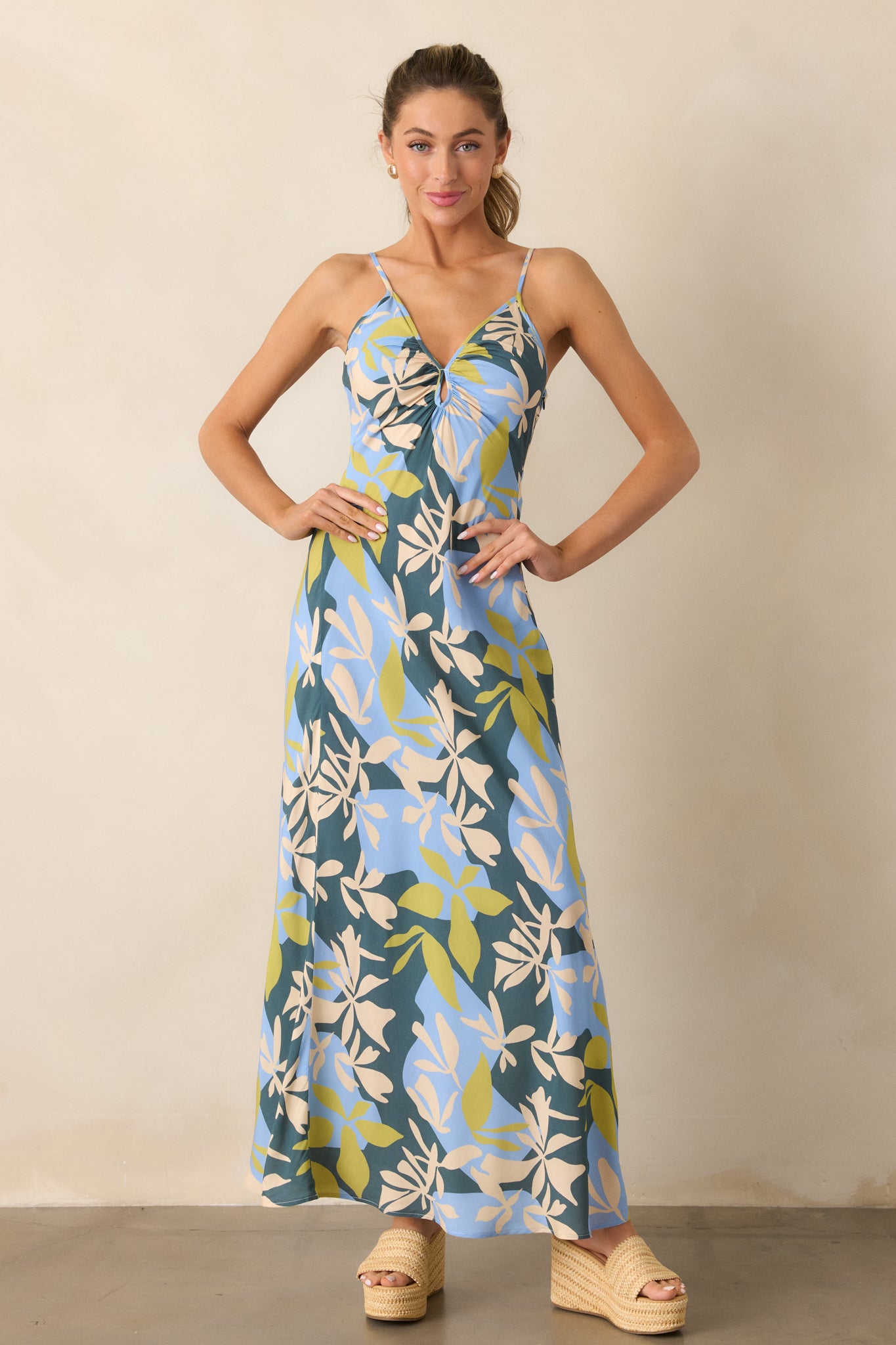 A complete look at the green dress, emphasizing its adjustable straps and elegant maxi design.