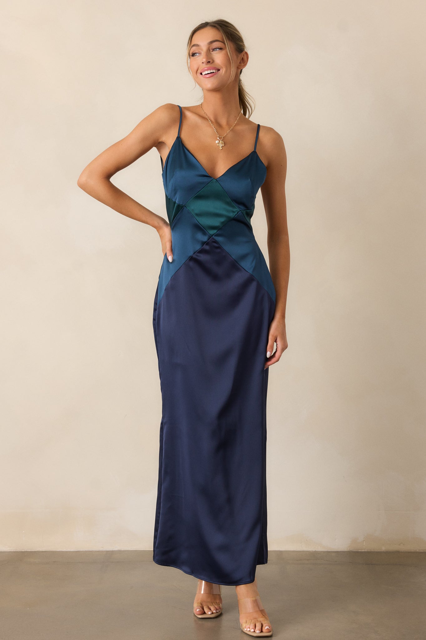 A full-length image of the midnight blue dress, highlighting its v-neckline, flowing silhouette, and bold diamond color-blocked design.